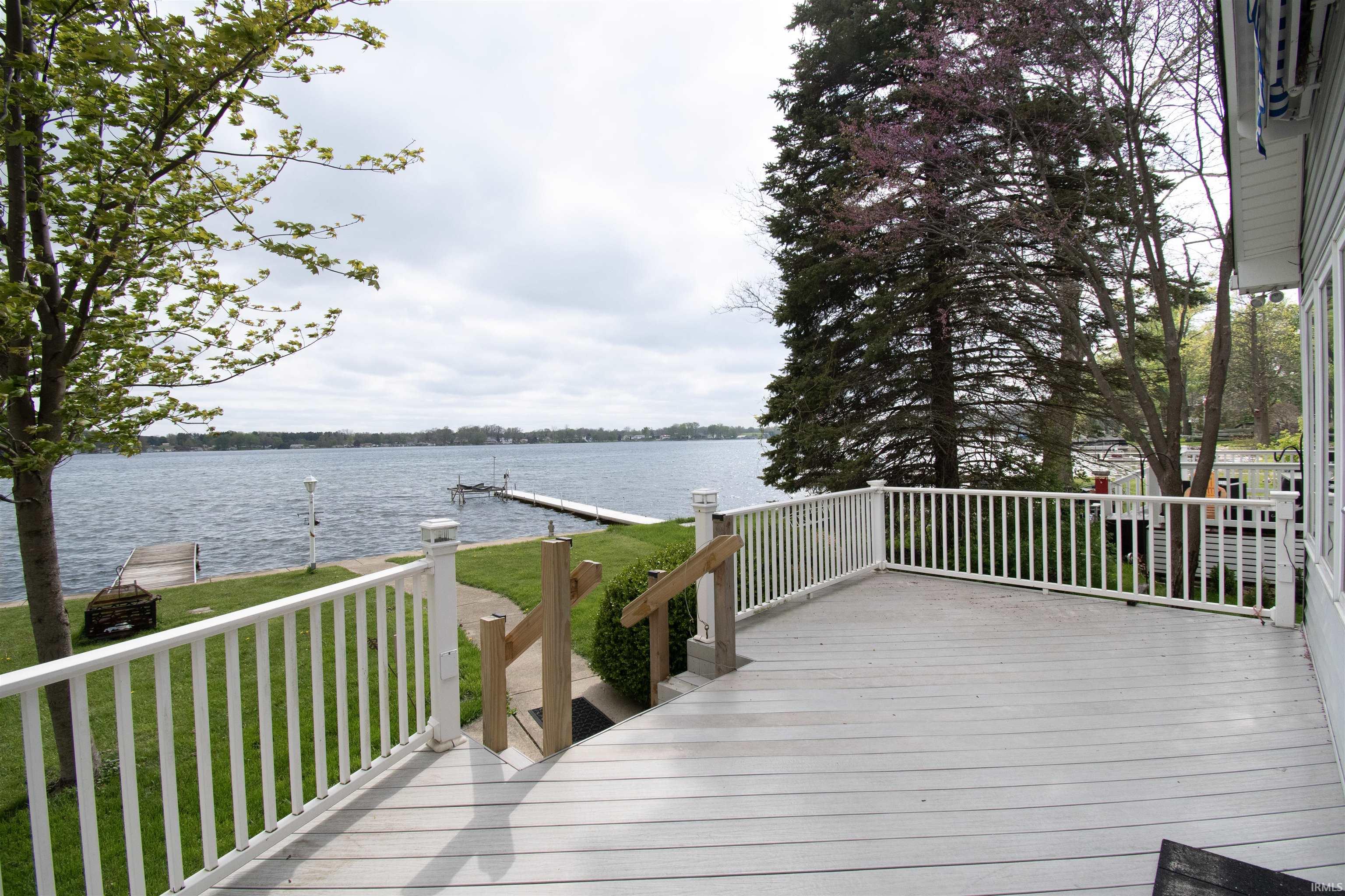 Expansive outdoor deck with white railing and post cap lighting
