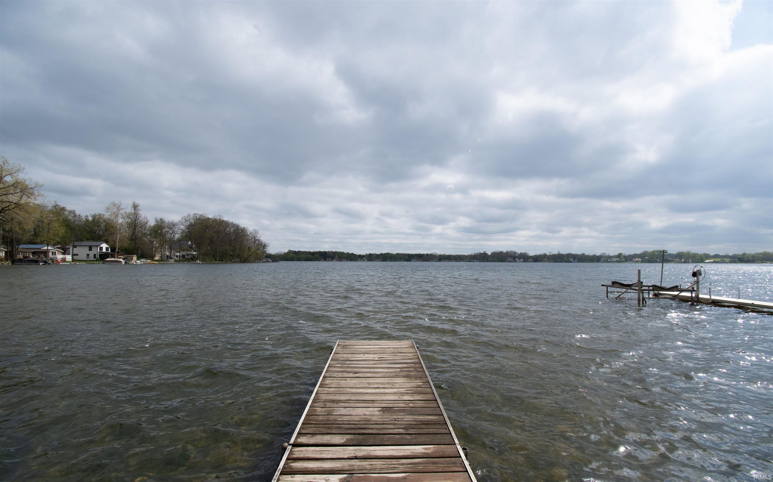Wood-plank dock extending into a wide expanse of water
