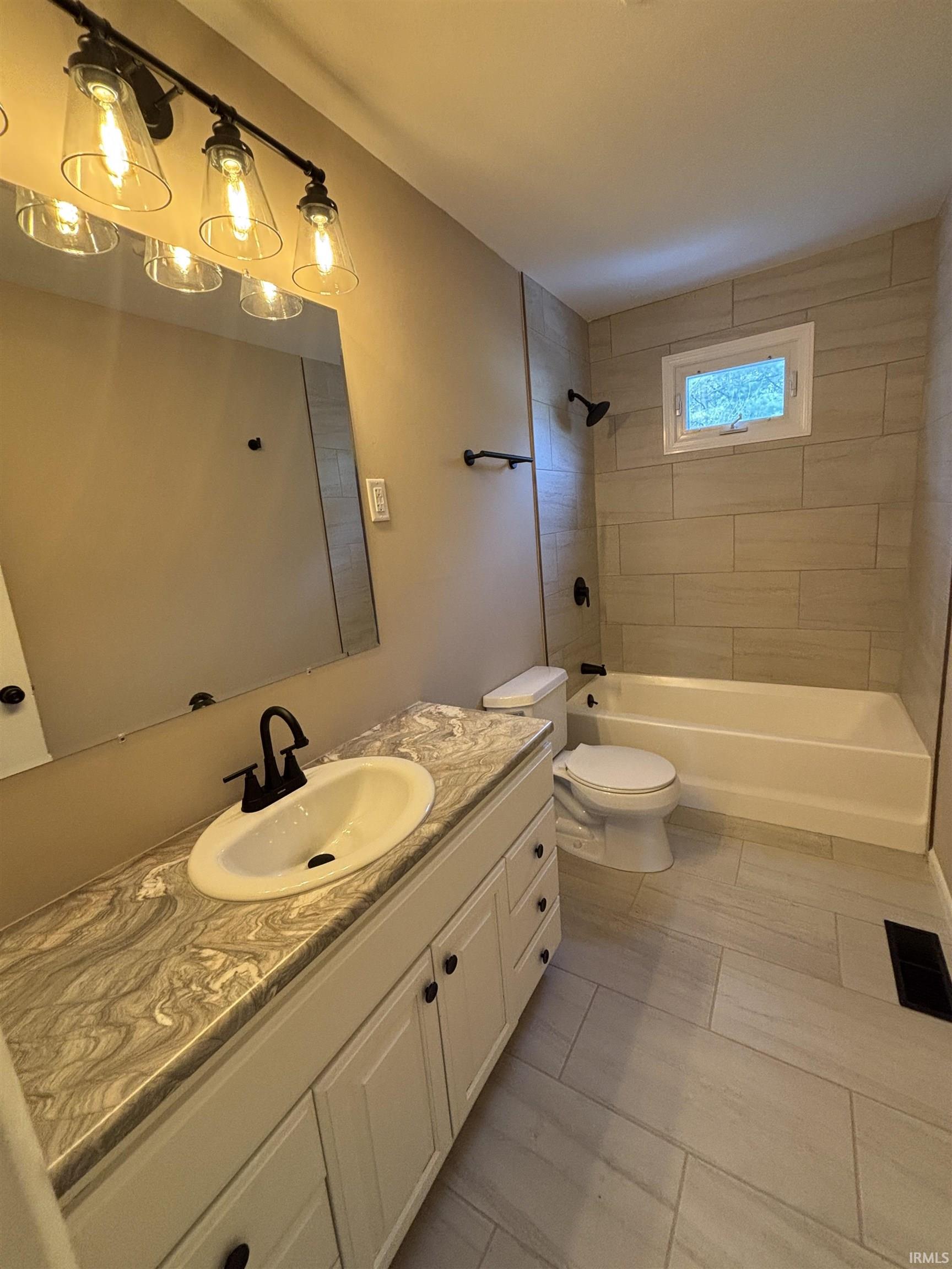 Full bath with vanity and tub / shower combination