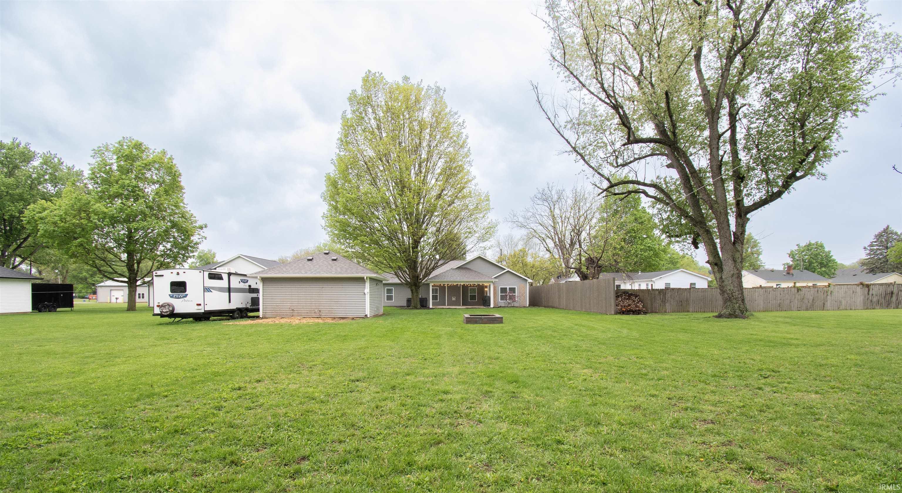 Expansive green lawn with mature trees