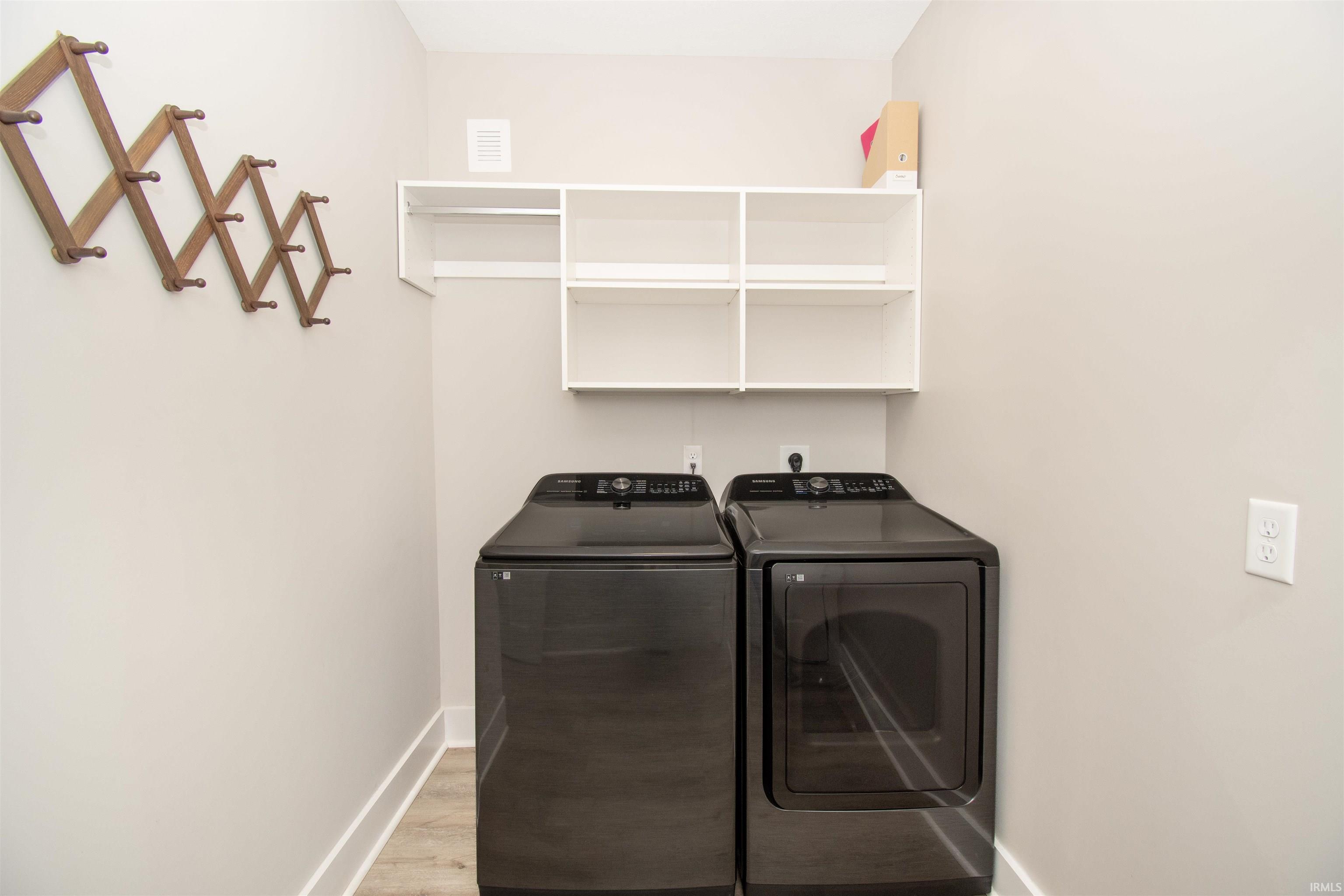 Dedicated laundry area with light wood-finish flooring