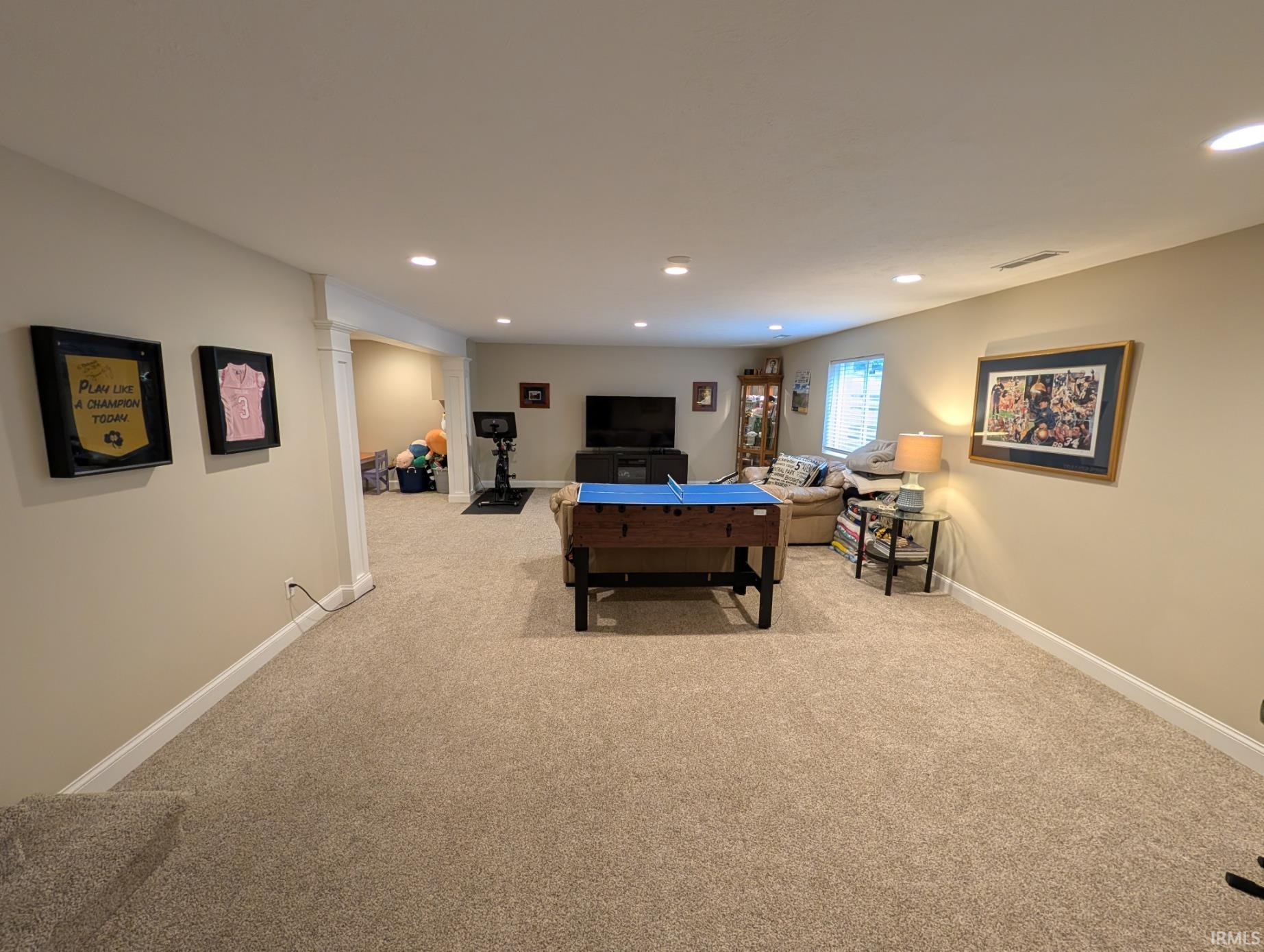 Spacious finished lower level featuring recessed lighting, light-toned carpeting, and crisp white baseboards