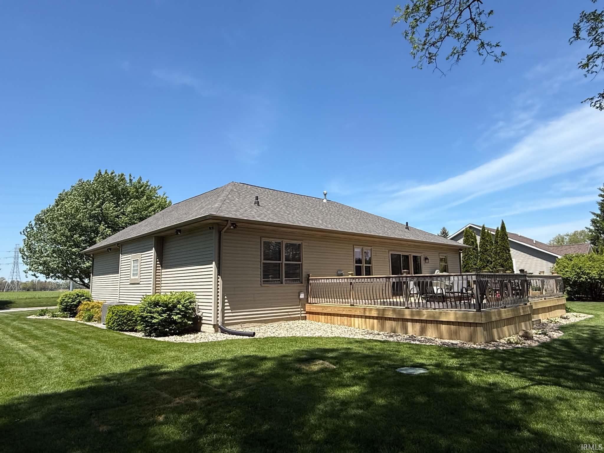 Expansive wooden deck featuring multiple levels and a spindle railing system