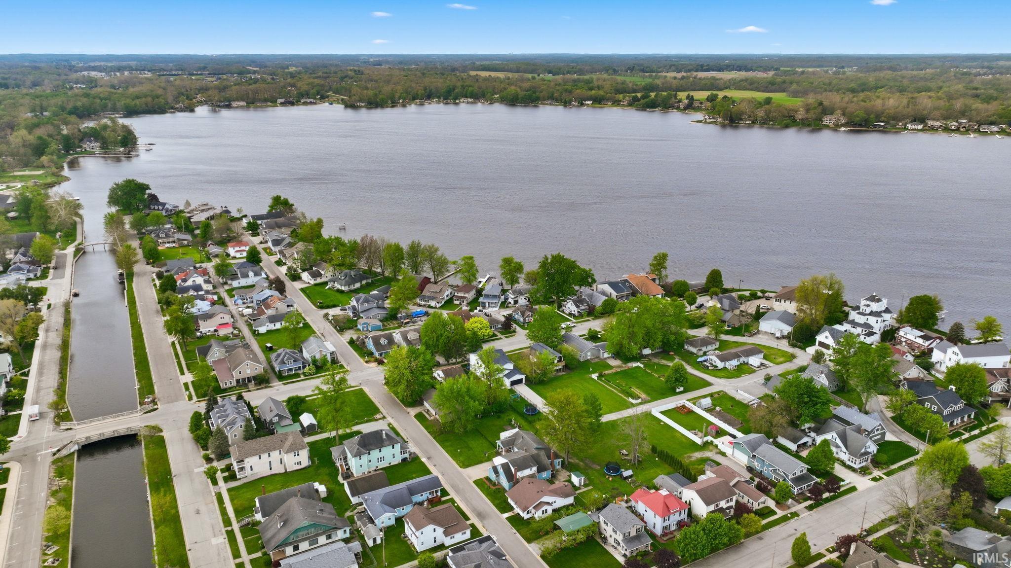 Aerial perspective showcasing a residential area bordering a substantial body of water