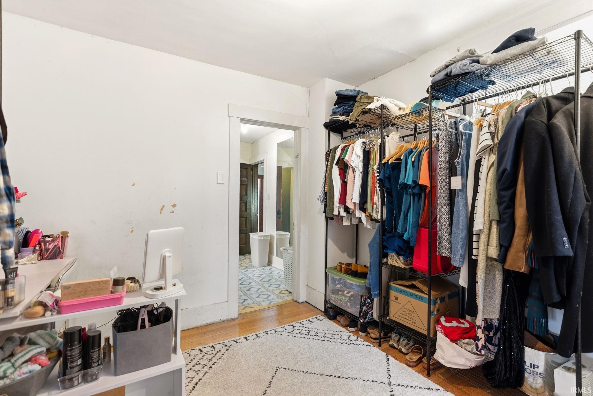 Walk in closet featuring light wood finished floors