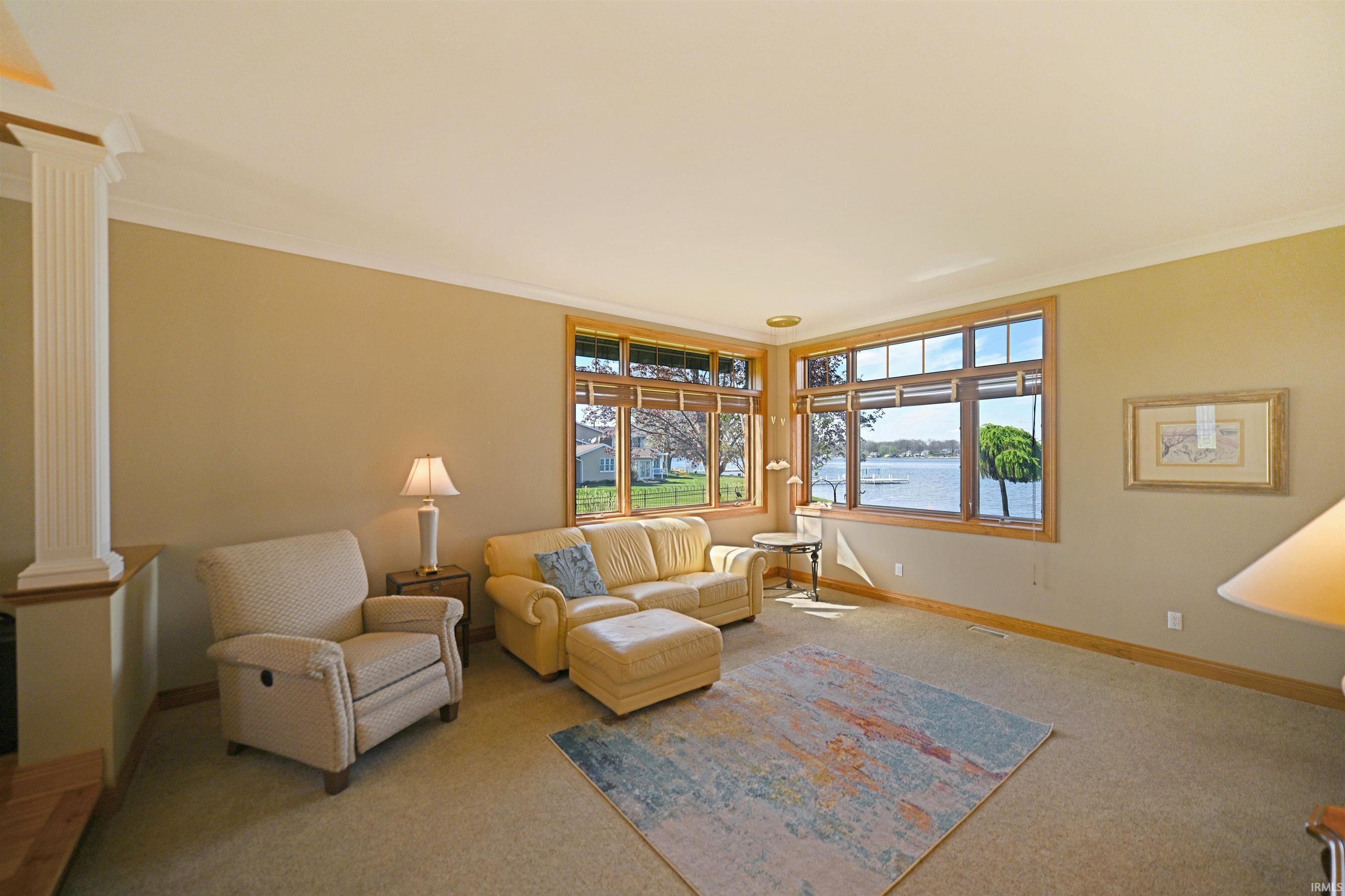 Expansive living area with large windows showcasing water scenery