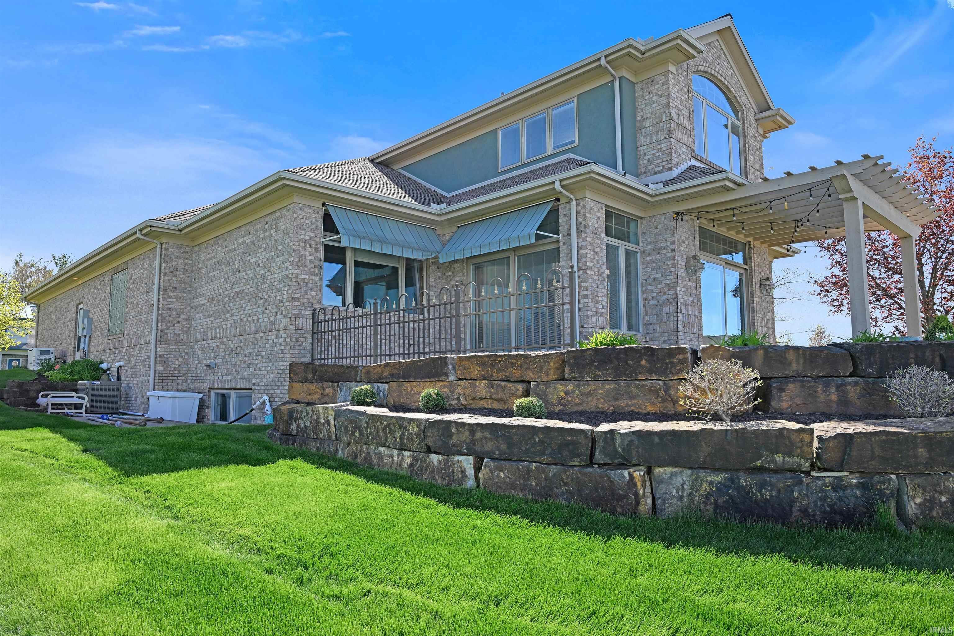 Stone block retaining walls define the terraced landscaping of this property