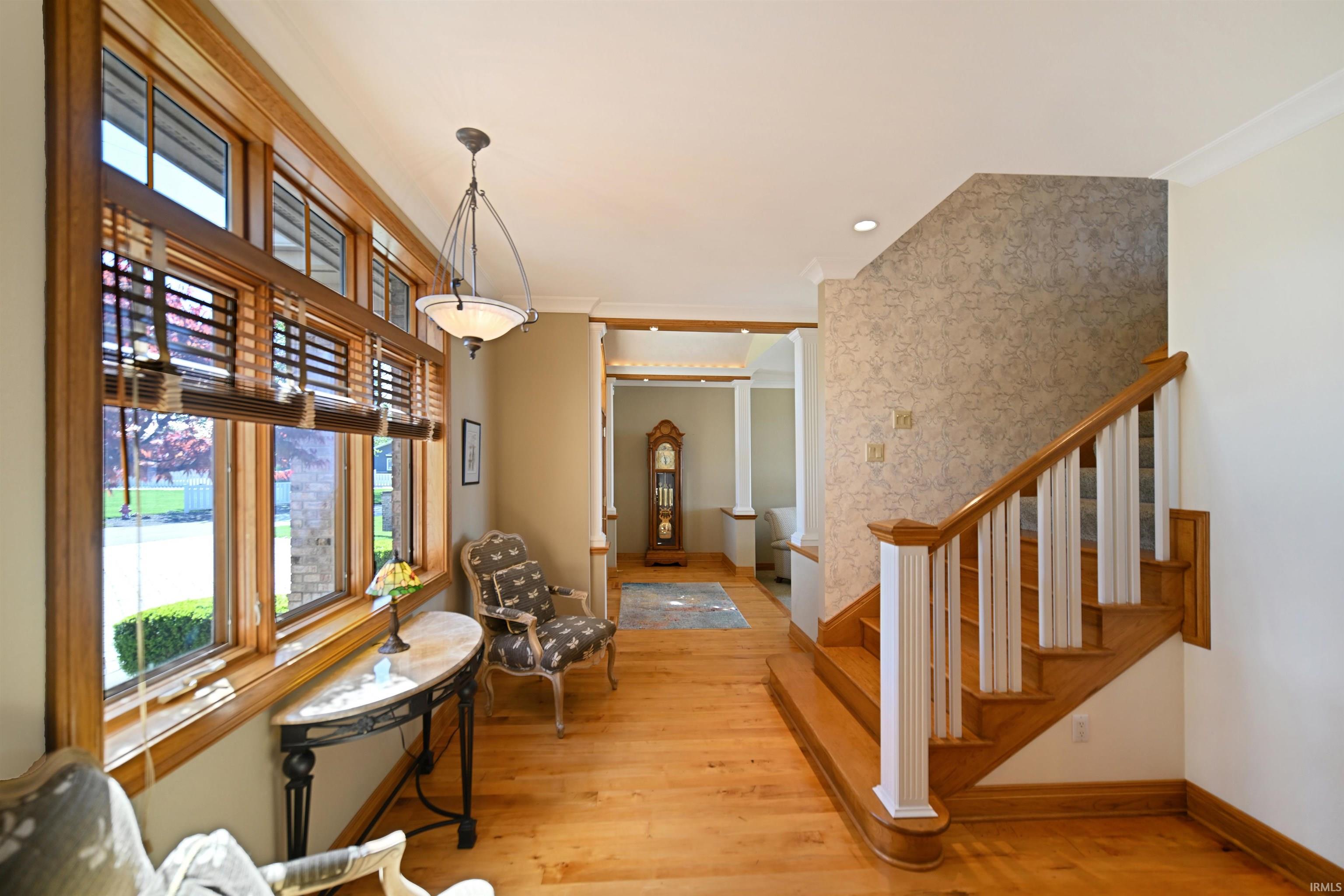 Light wood-finish flooring extending through the entry hall