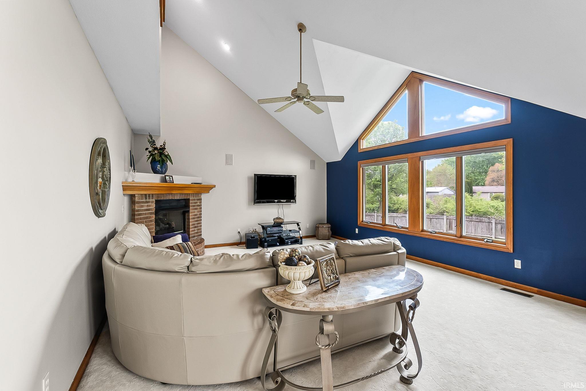 Vaulted ceilings with recessed lighting, complemented by a ceiling fan