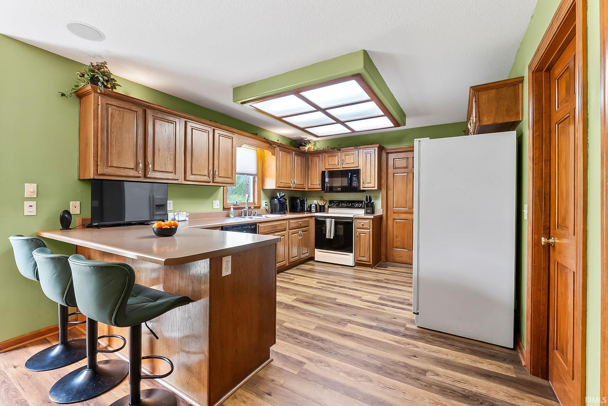 Kitchen featuring wood-finish flooring and wood cabinetry