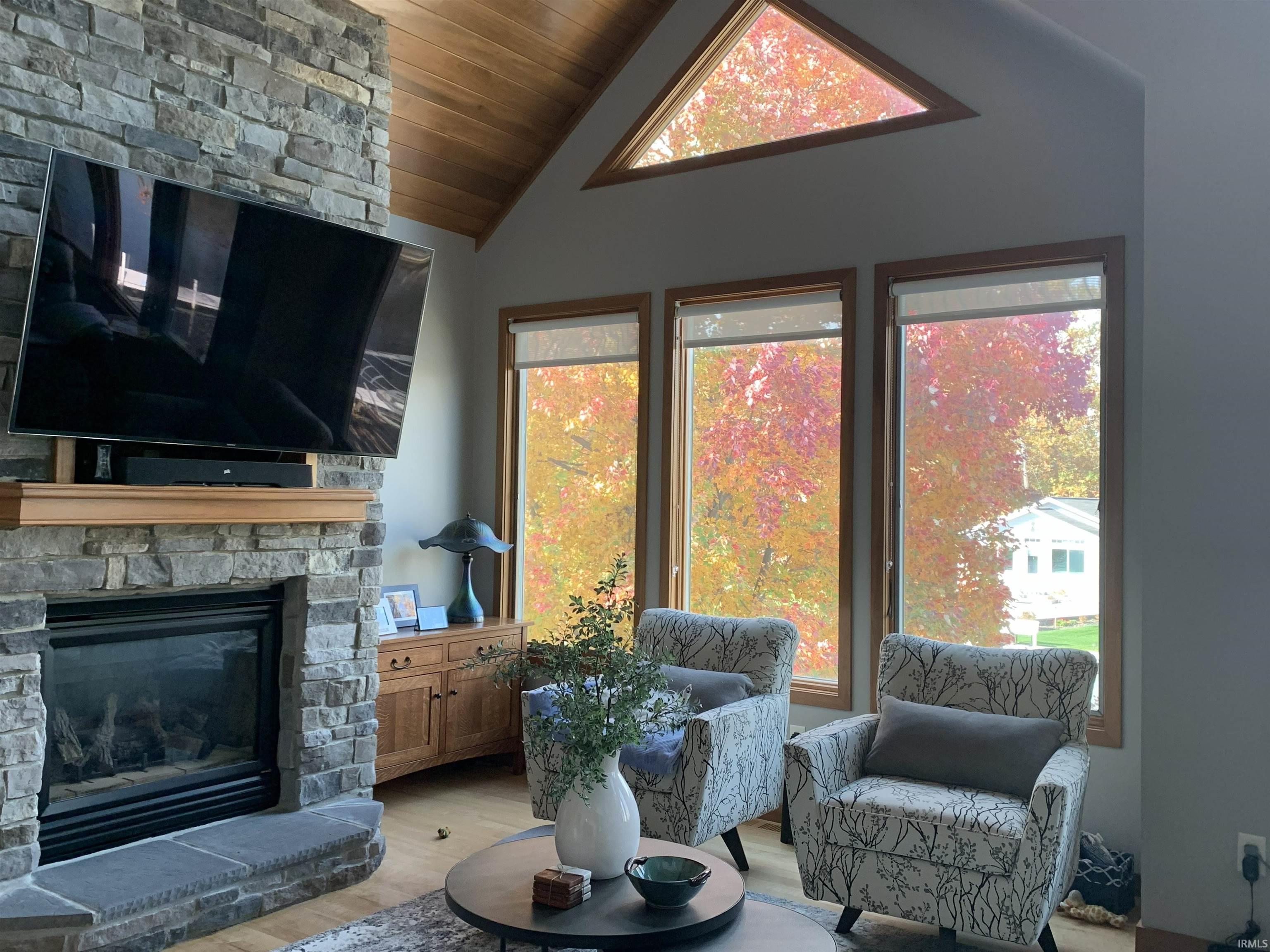 Stone-clad fireplace with a wood mantel and hearth