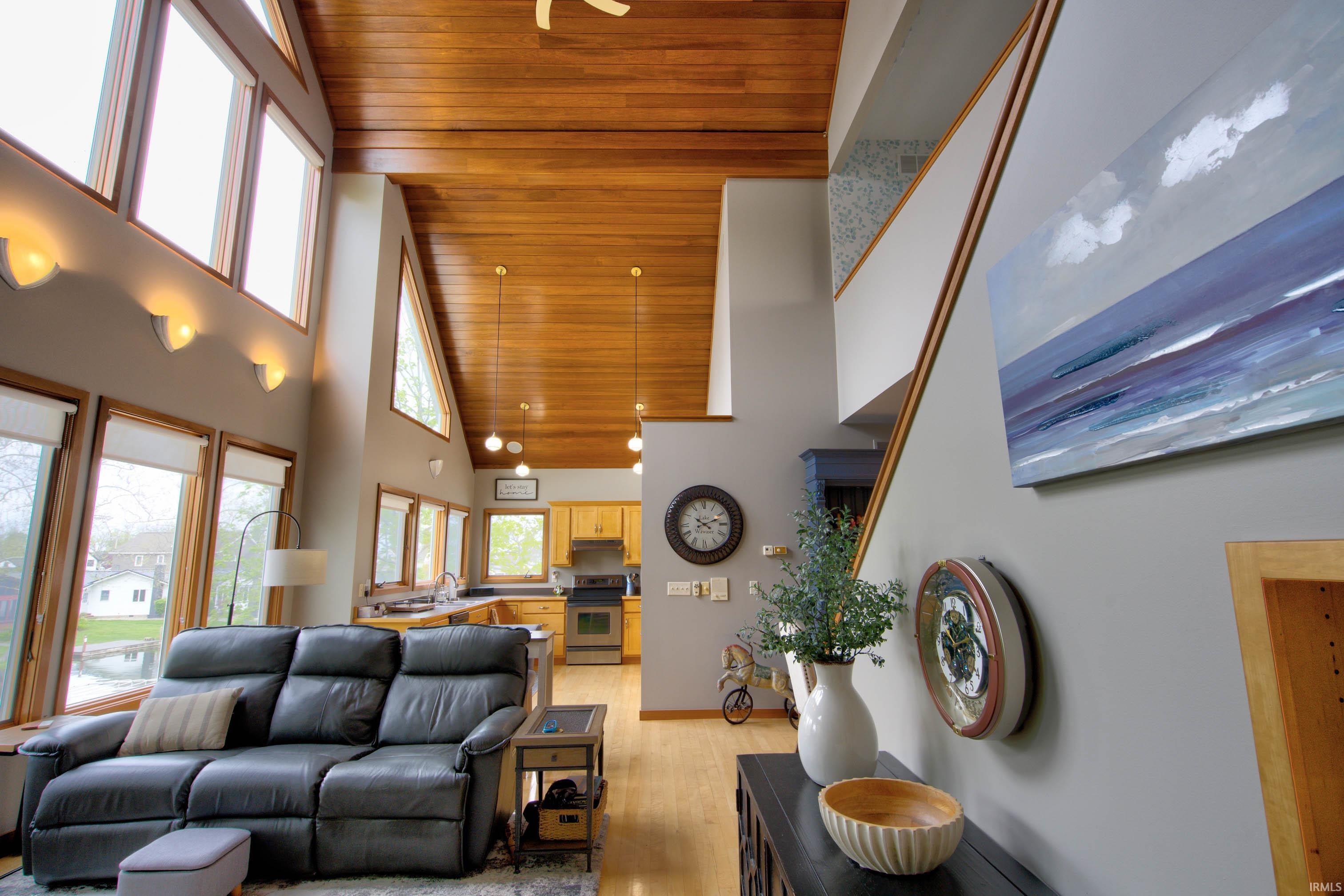 Vaulted wood-paneled ceilings highlight the open-concept living space