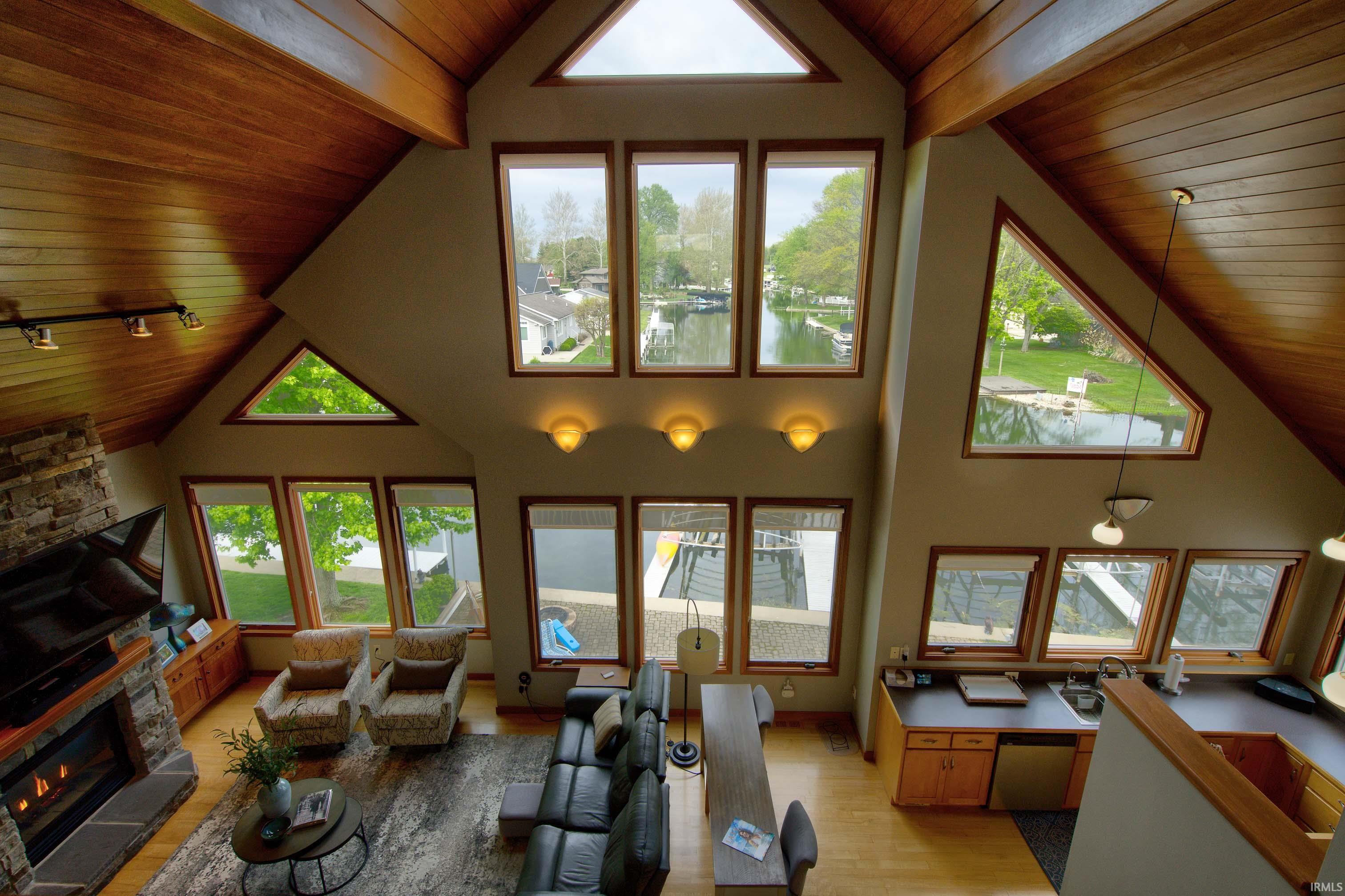 Vaulted wood-paneled ceilings complement abundant natural light from numerous windows