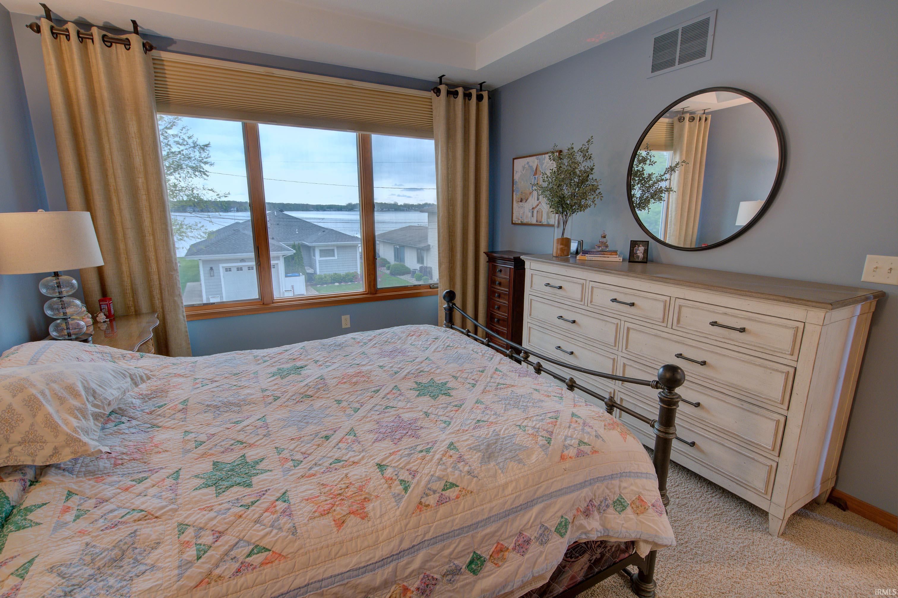 Expansive window with natural wood trim offering water scenery