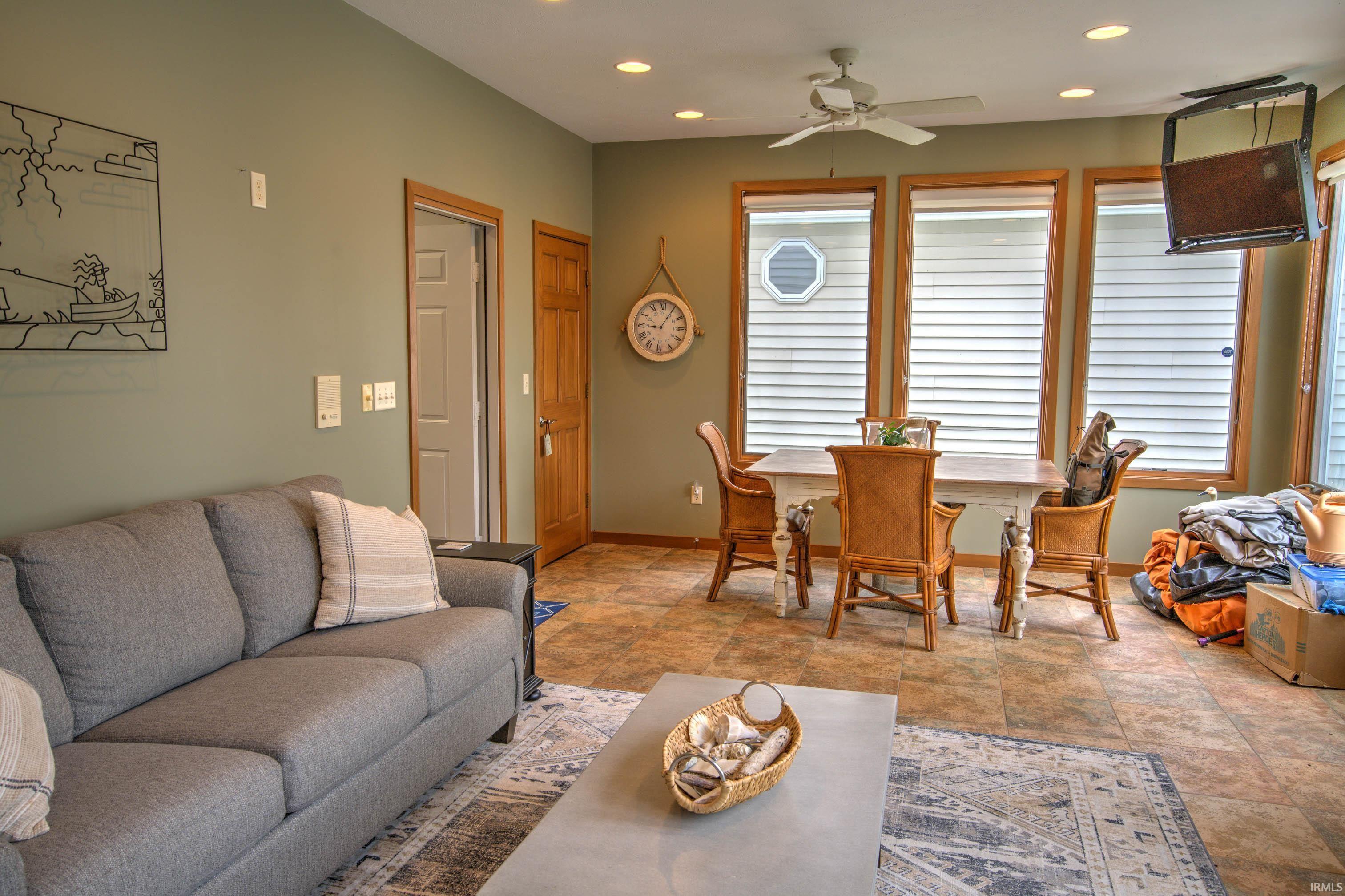 Open-concept room featuring light green walls and wood-finish flooring