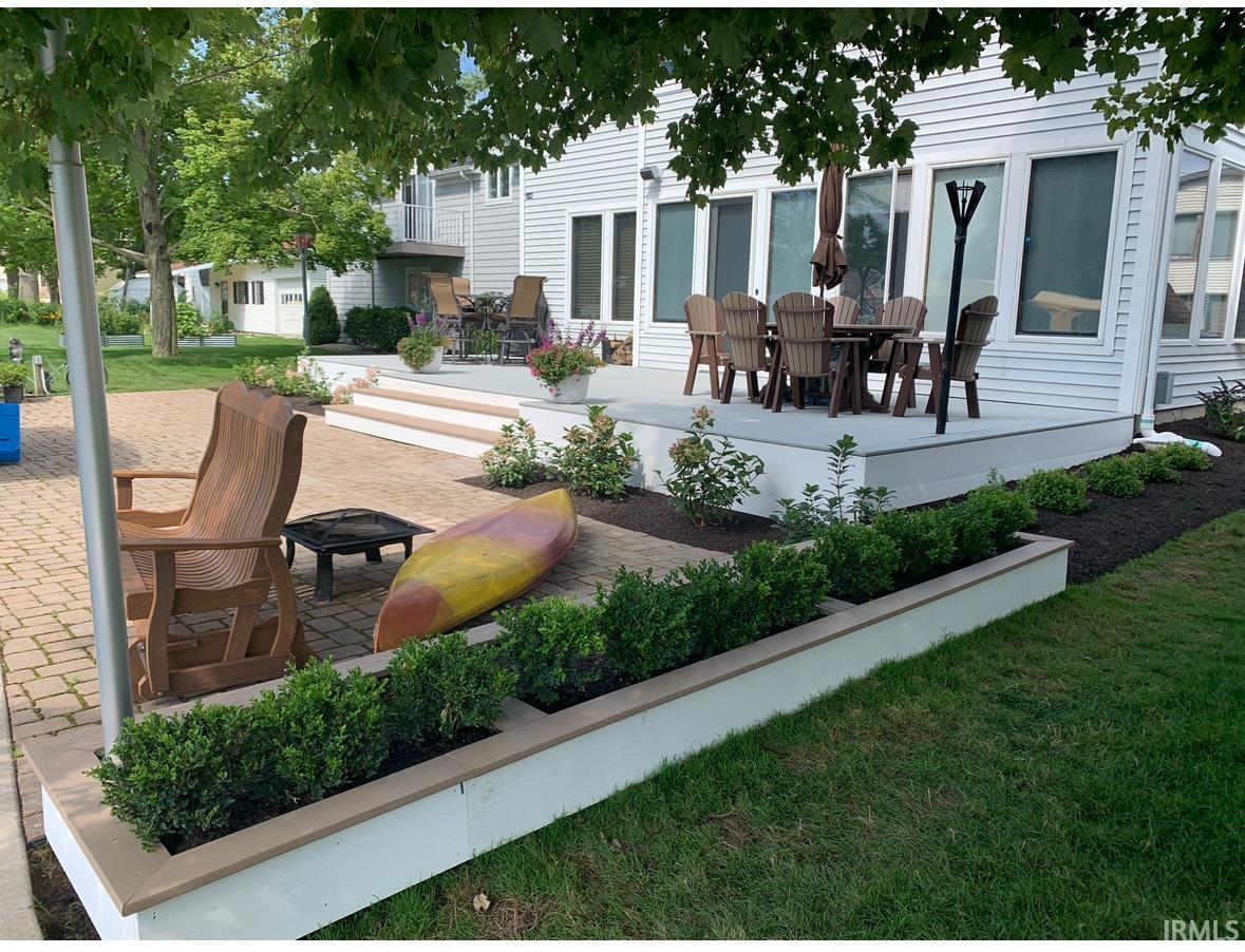 Expansive outdoor living area featuring a paver patio and a multi-level deck