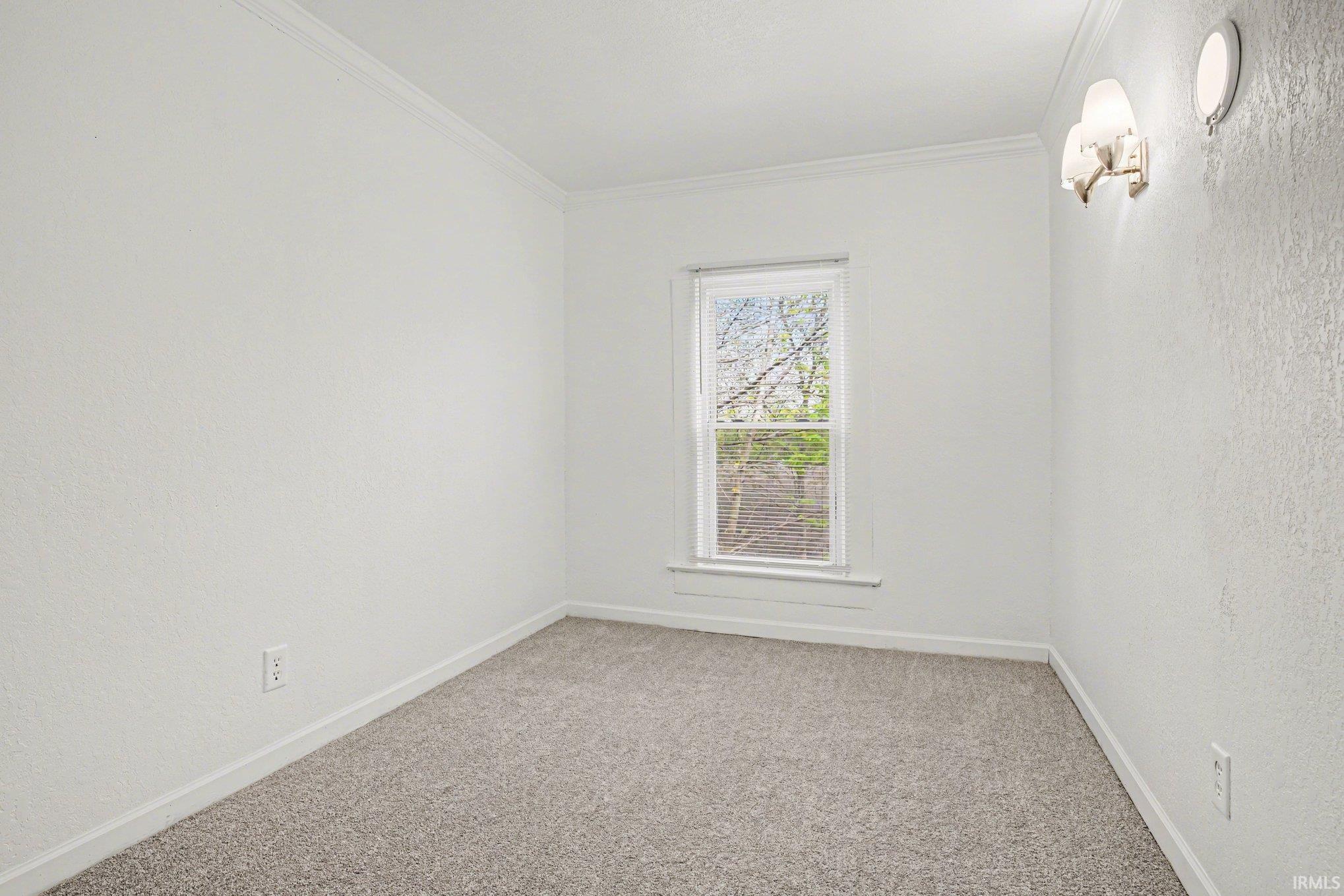 Neutral wall finishes, light grey carpeting, and white trim create a bright aesthetic
