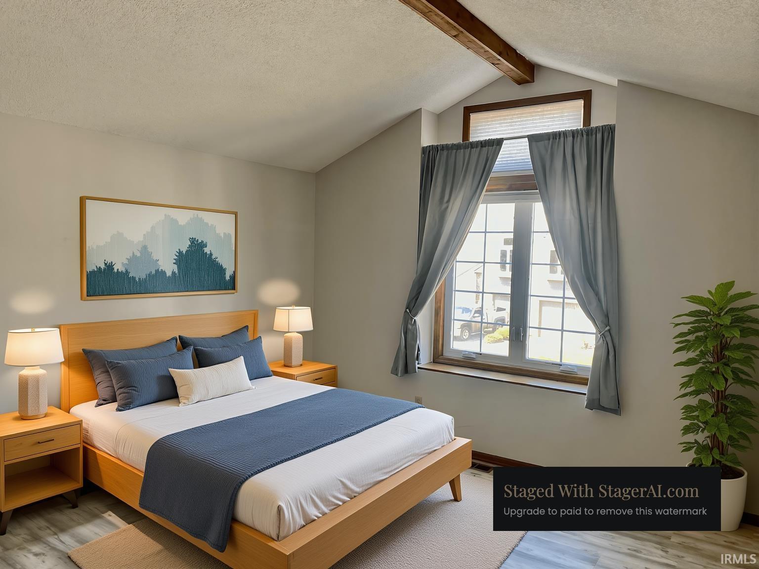 Vaulted ceiling with exposed wood beam and a large window featuring an upper transom