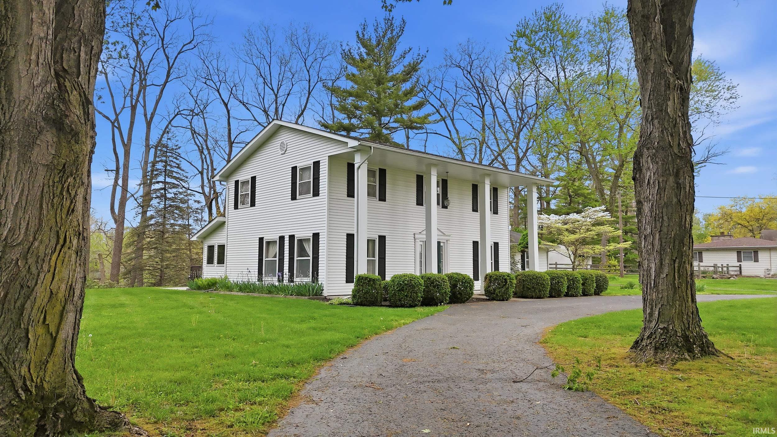 White two-story residence with black window shutters