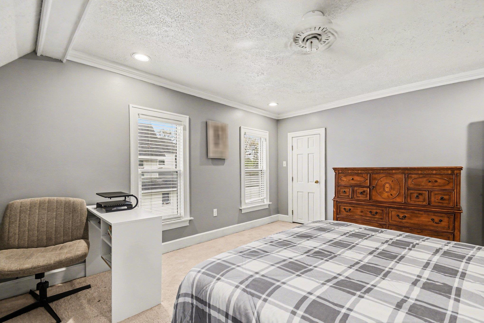 Room featuring two windows with blinds, recessed lighting, crown molding, and a built-in ceiling fan
