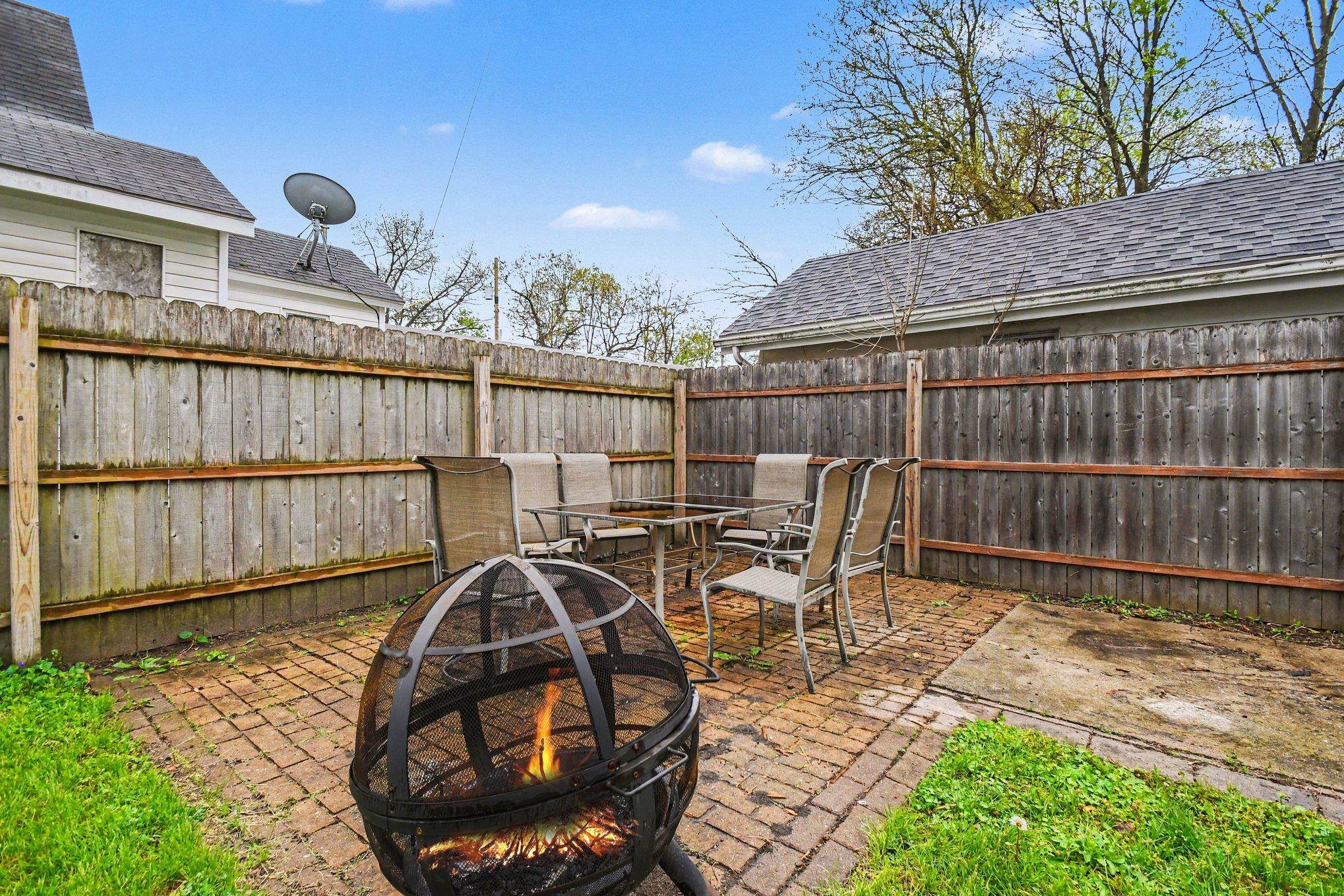 Brick paver patio area featuring a privacy fence and a dedicated outdoor space