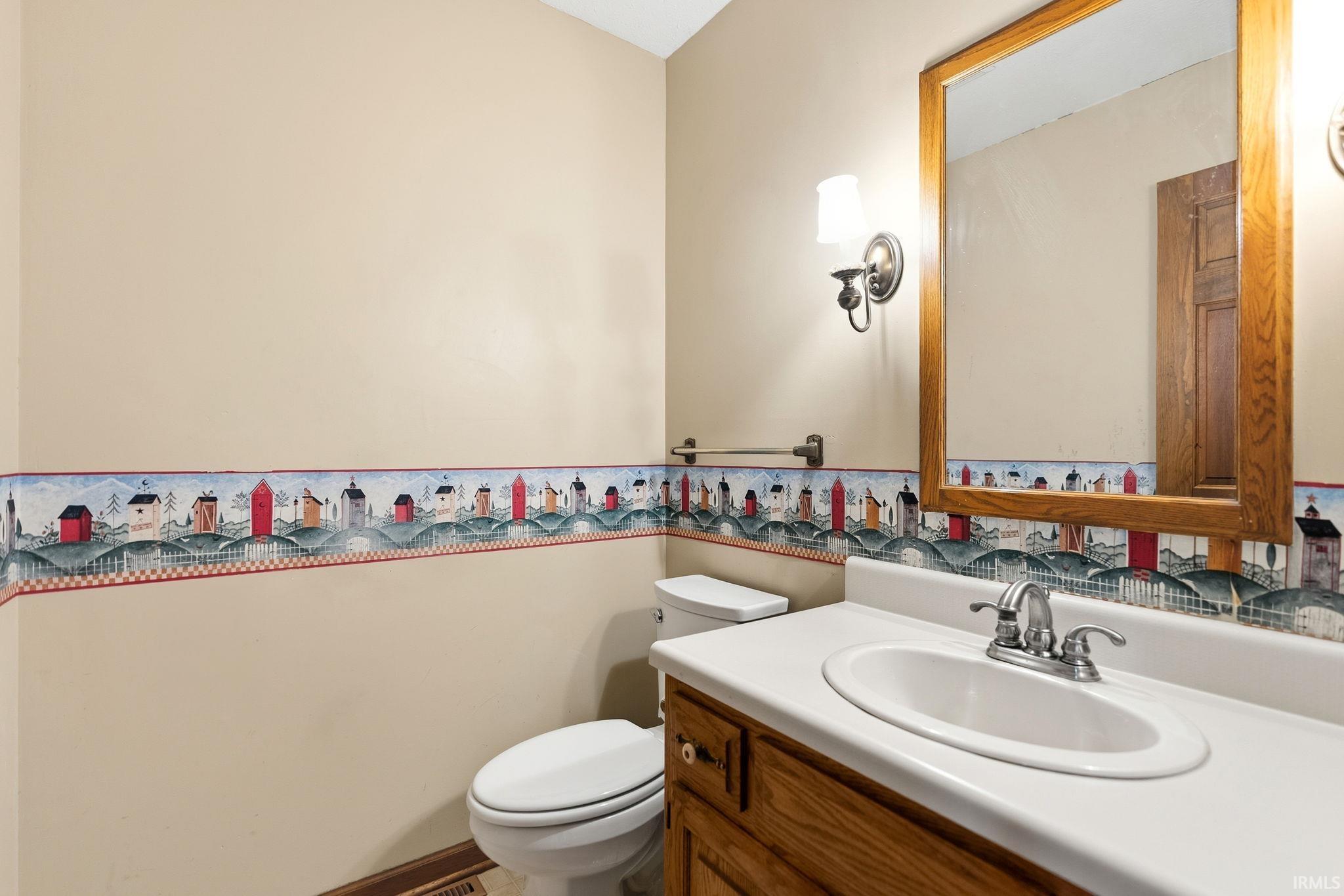 Bathroom vanity with an integrated white sink, chrome faucet, and wood-finish cabinetry