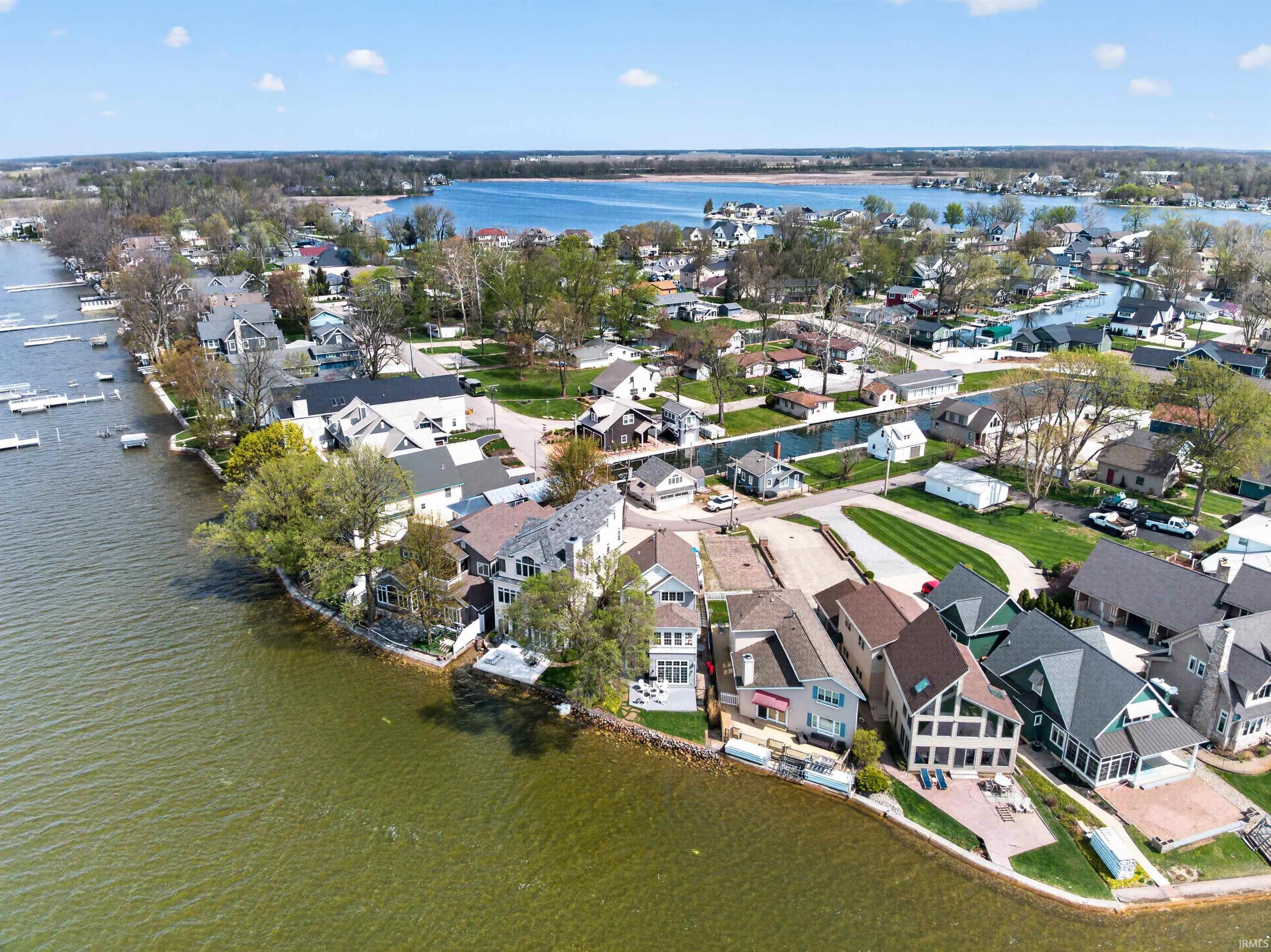 Aerial overview of property's location featuring a large body of water and nearby suburban area