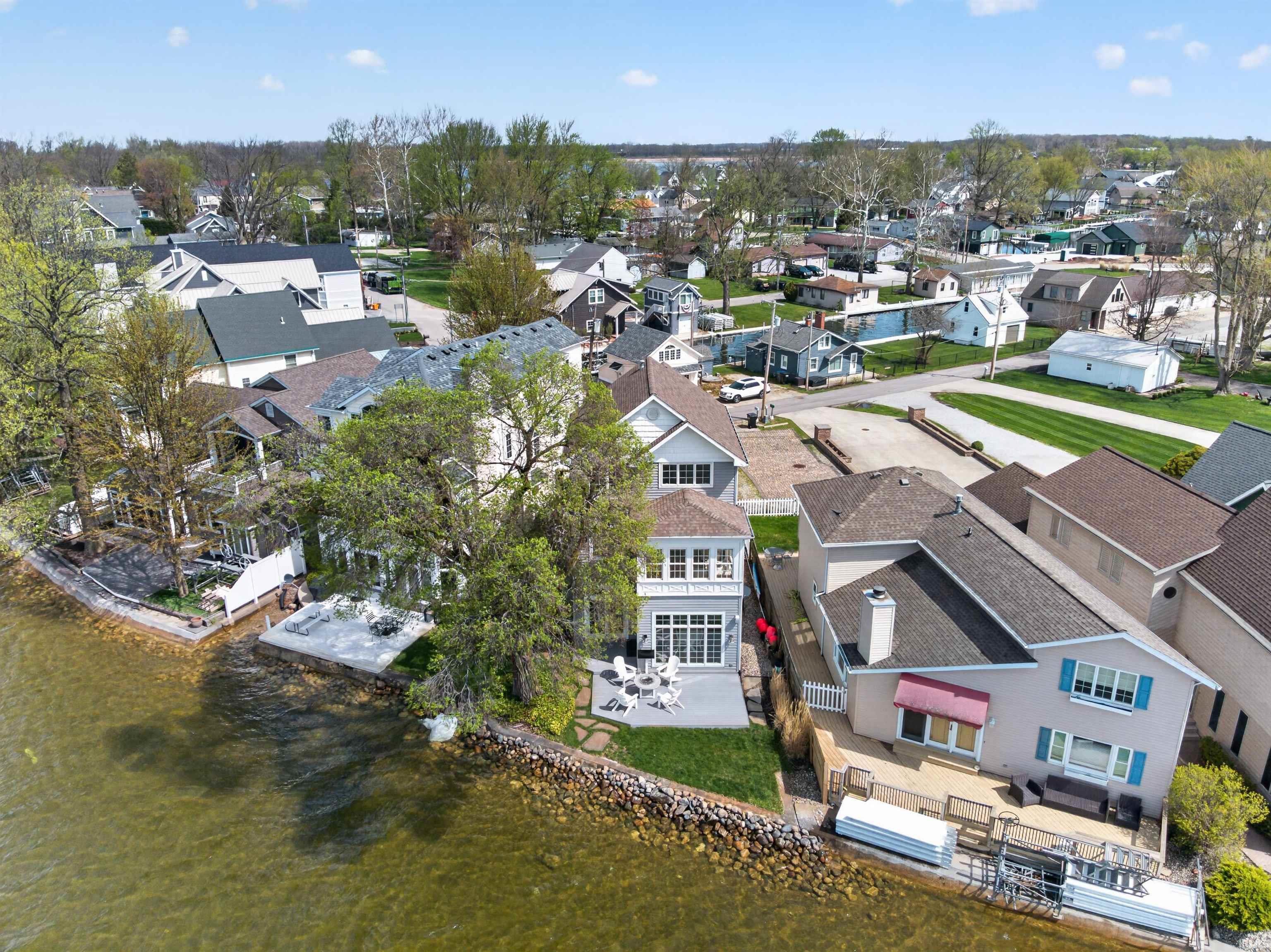 Aerial perspective of suburban area featuring a nearby body of water