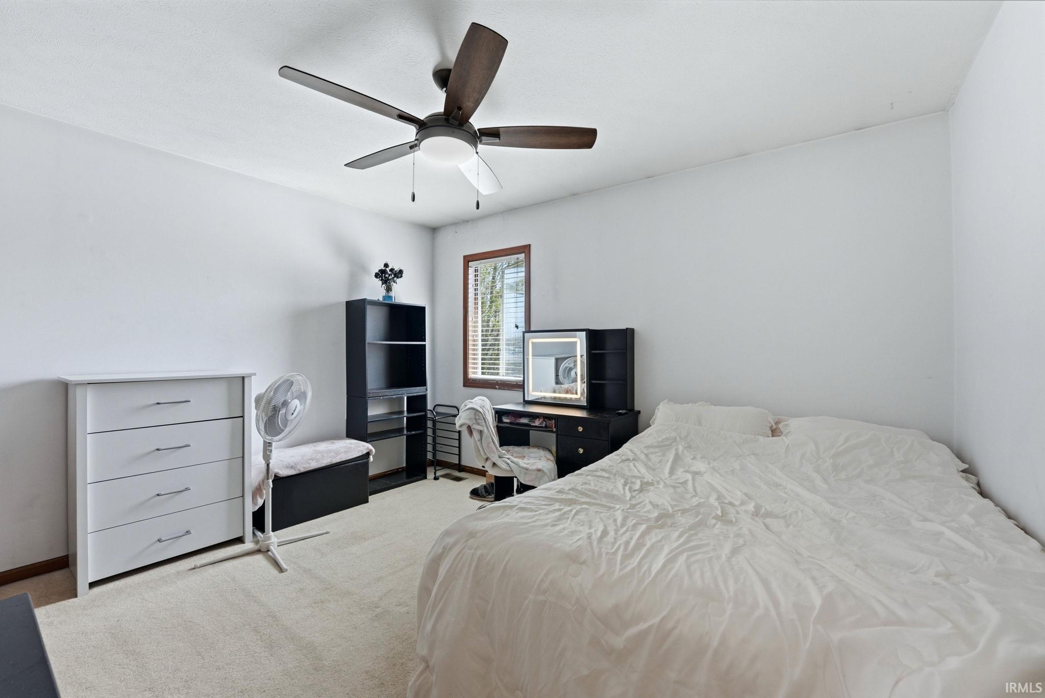 Neutral tone wall palette with wood-trim window and ceiling fan