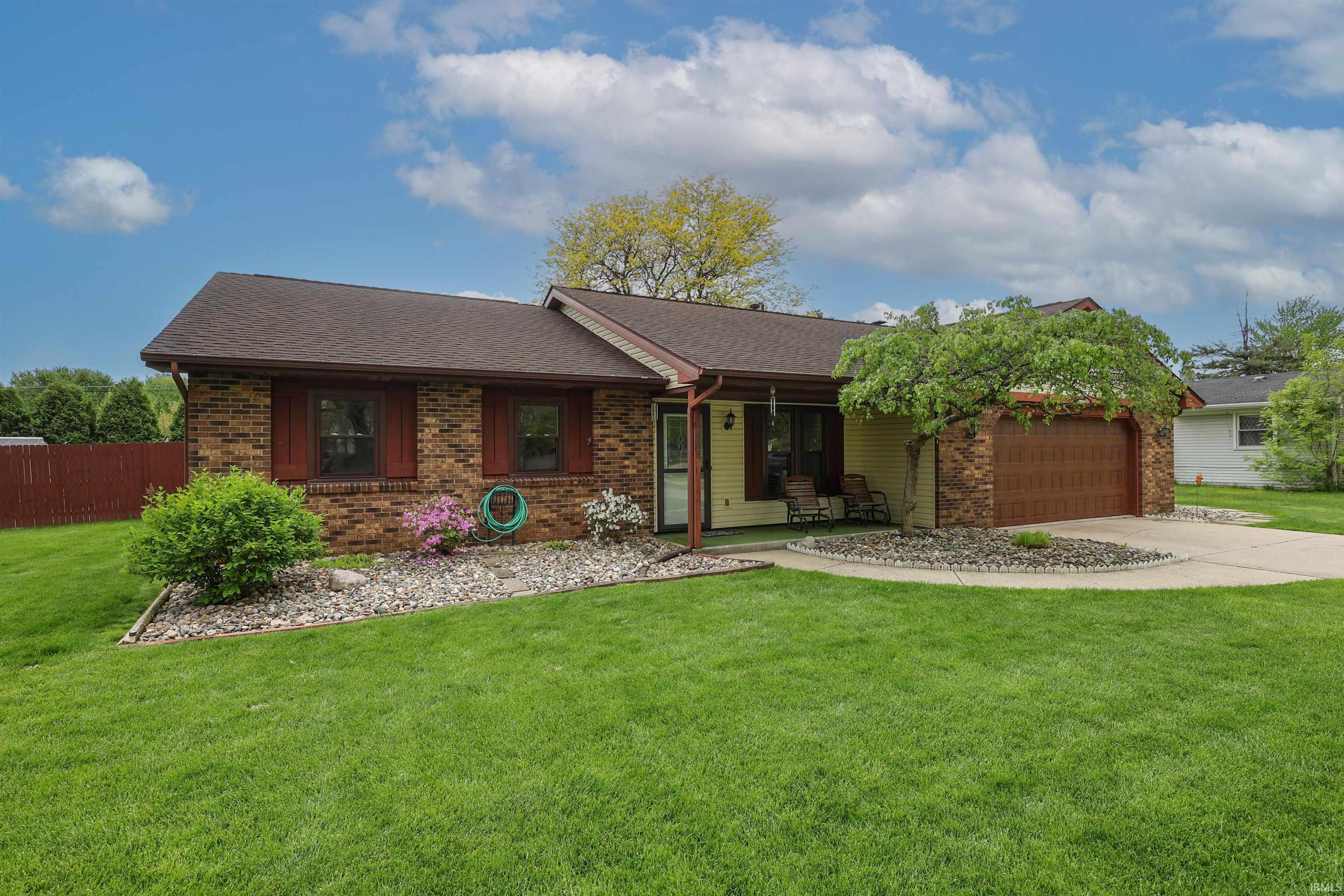 Brick and siding exterior featuring a covered front entry