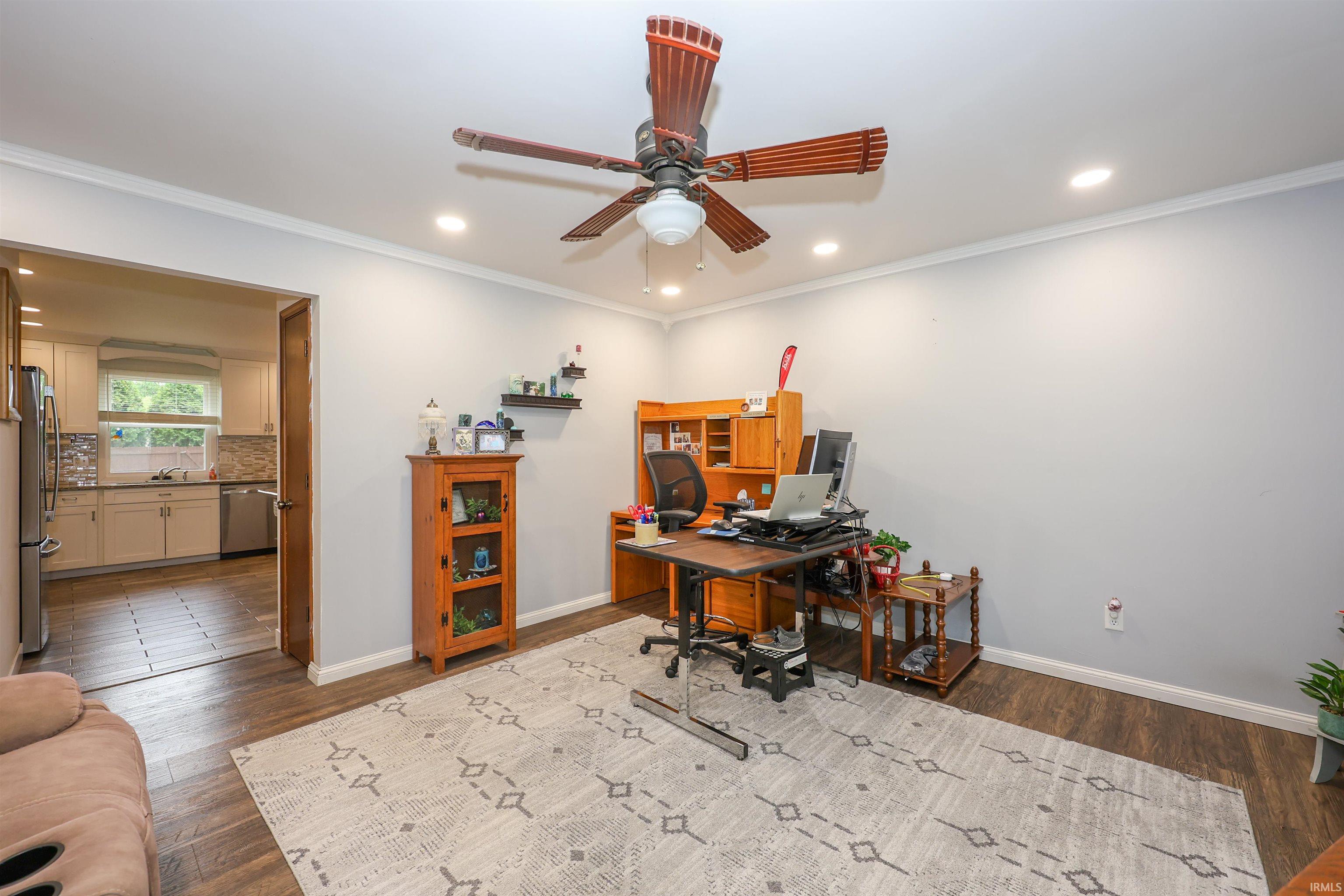 Versatile interior space featuring wood-finish flooring, recessed lighting, and crown molding