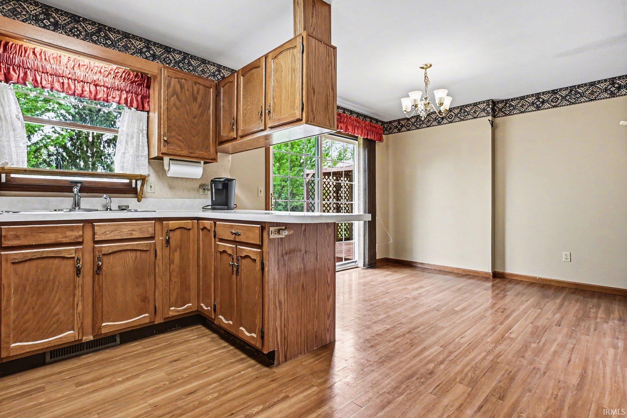 Kitchen and dining area featuring wood-finish flooring