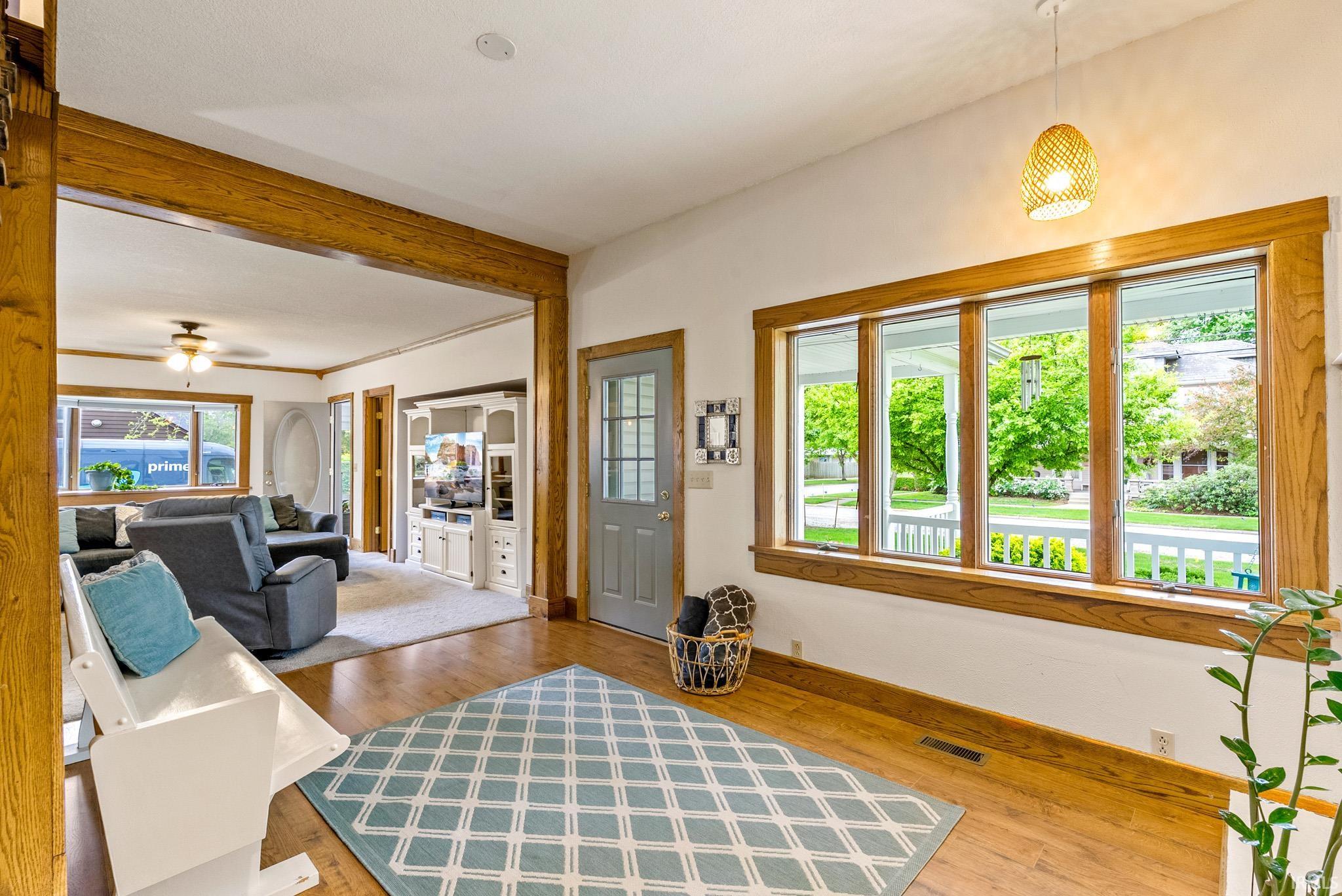 Bright entry with hardwood flooring and a light wood-finish trim throughout