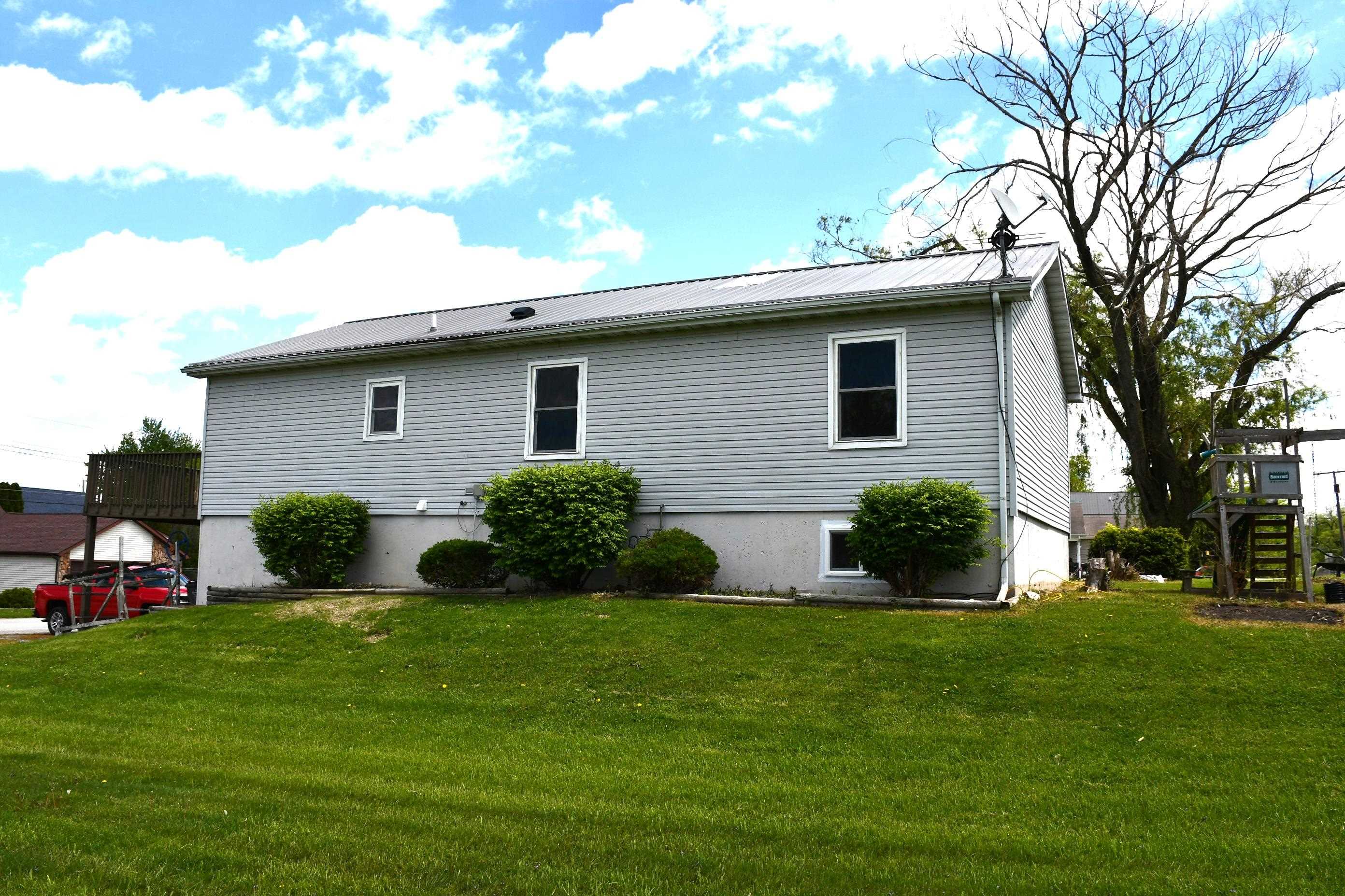 Light gray horizontal siding with a metal roof