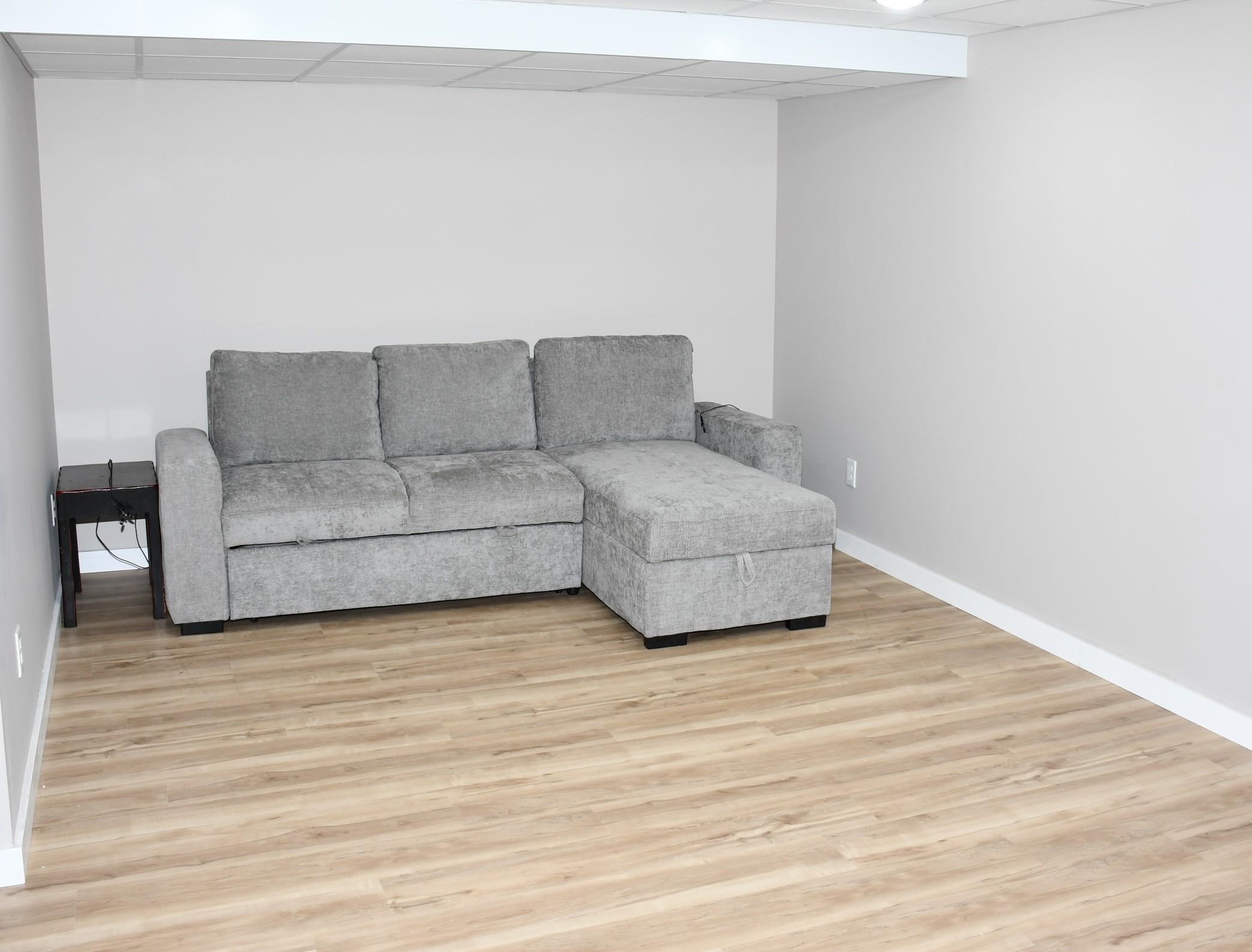 Bright interior space featuring light-toned walls and wood-finish flooring