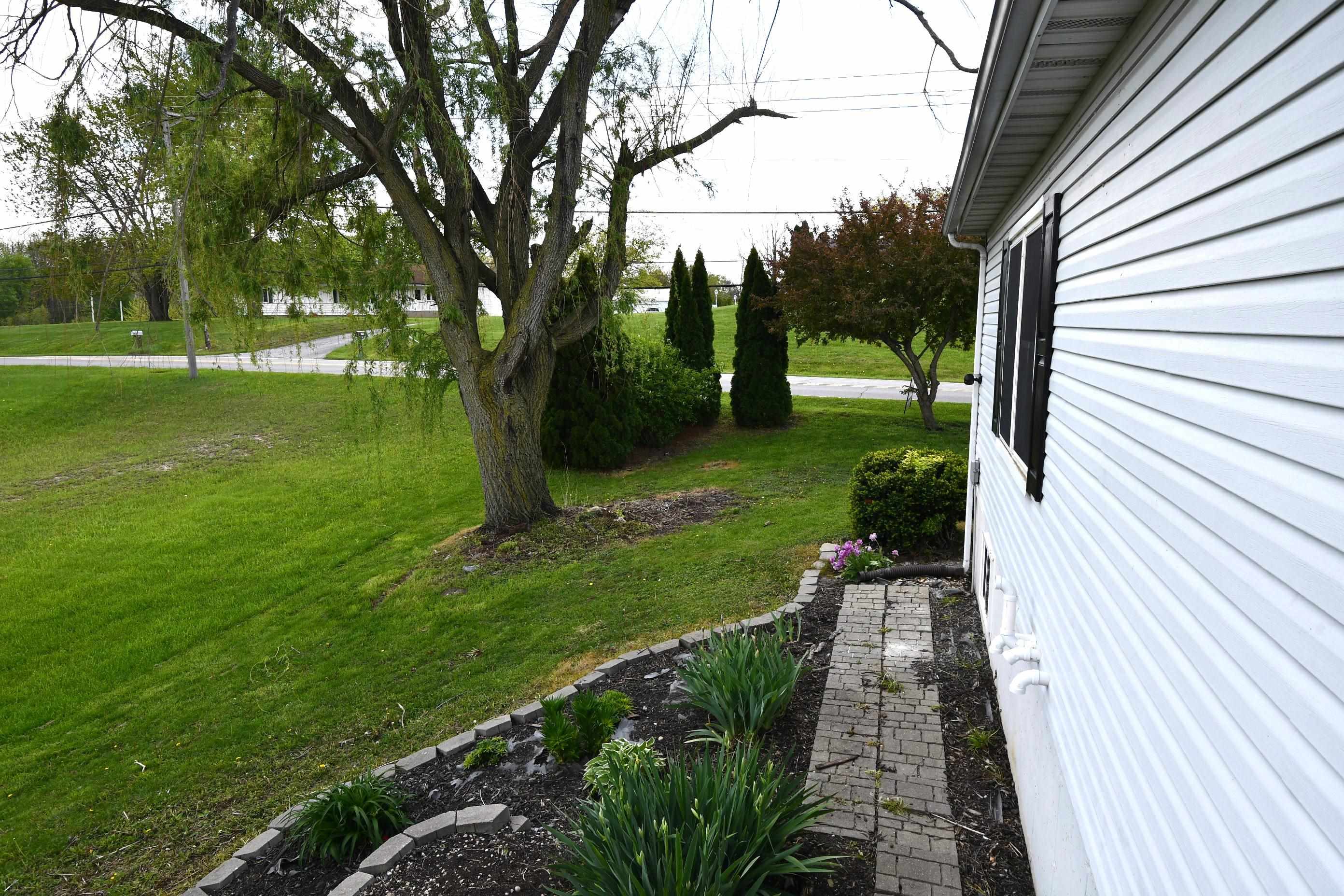 White horizontal siding with black window shutters