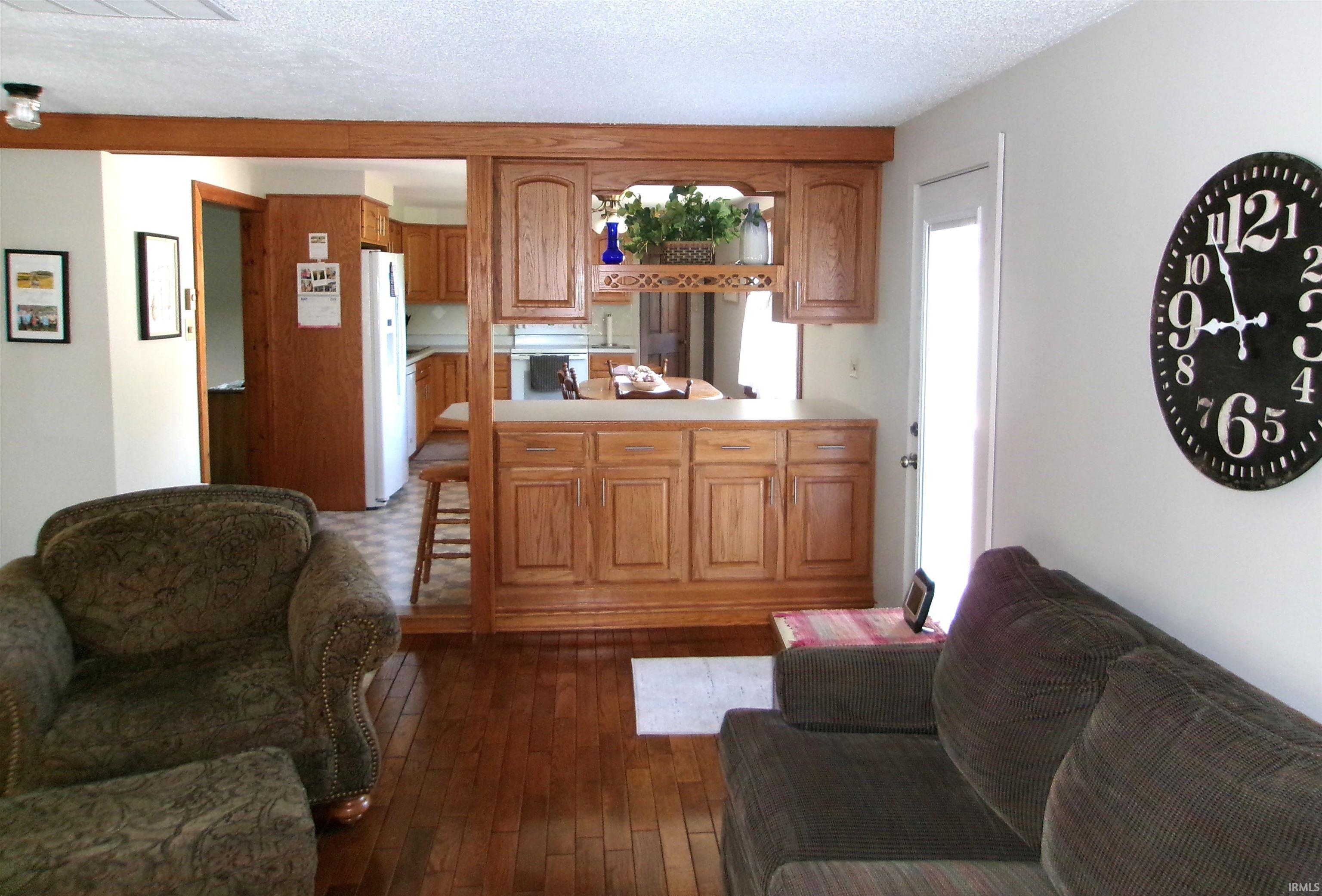 Open-concept living space featuring wood-finish flooring