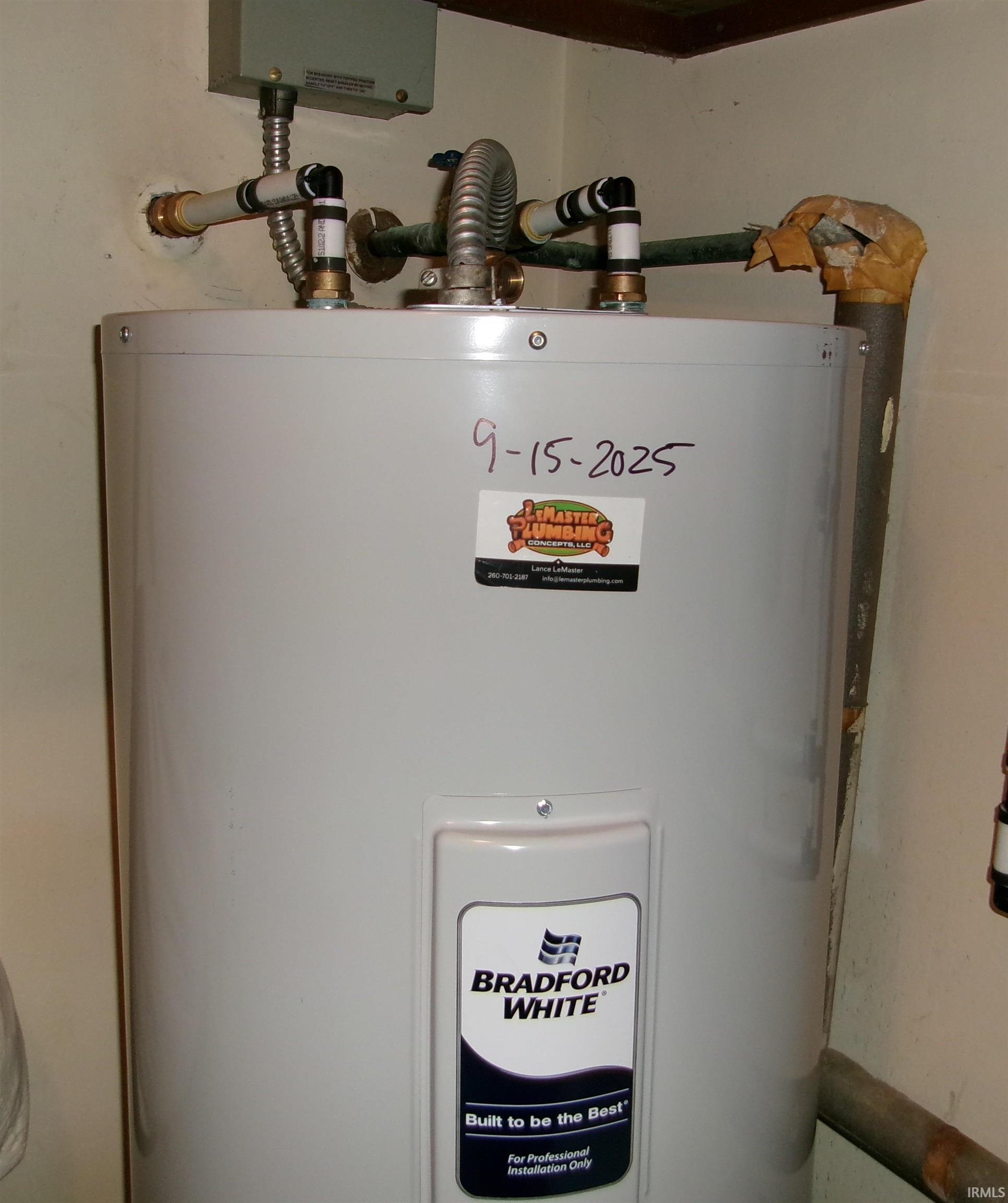Bradford White water heater featuring top-mounted plumbing connections and an insulated exhaust pipe
