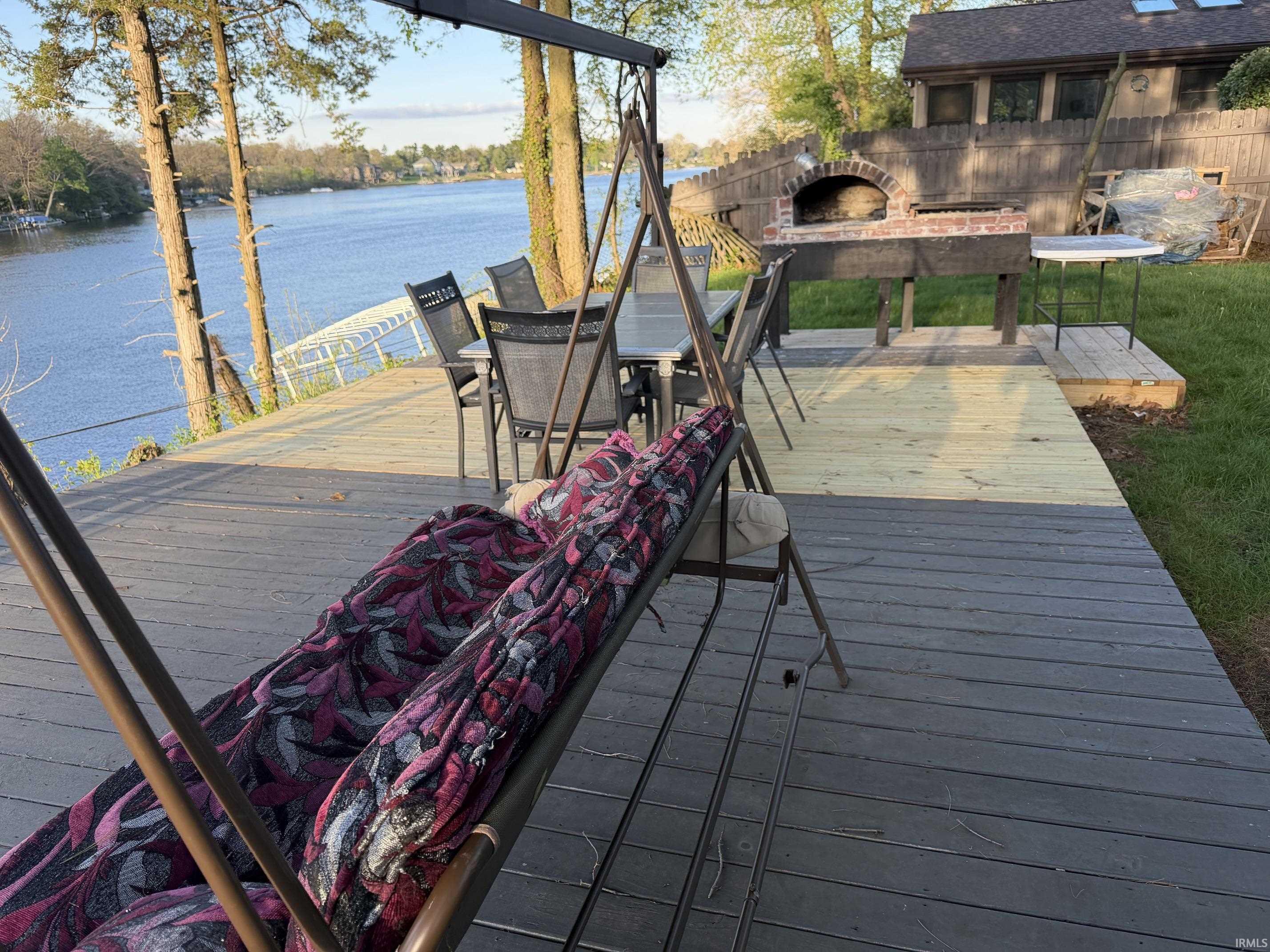Expansive multi-level wood deck with a water backdrop