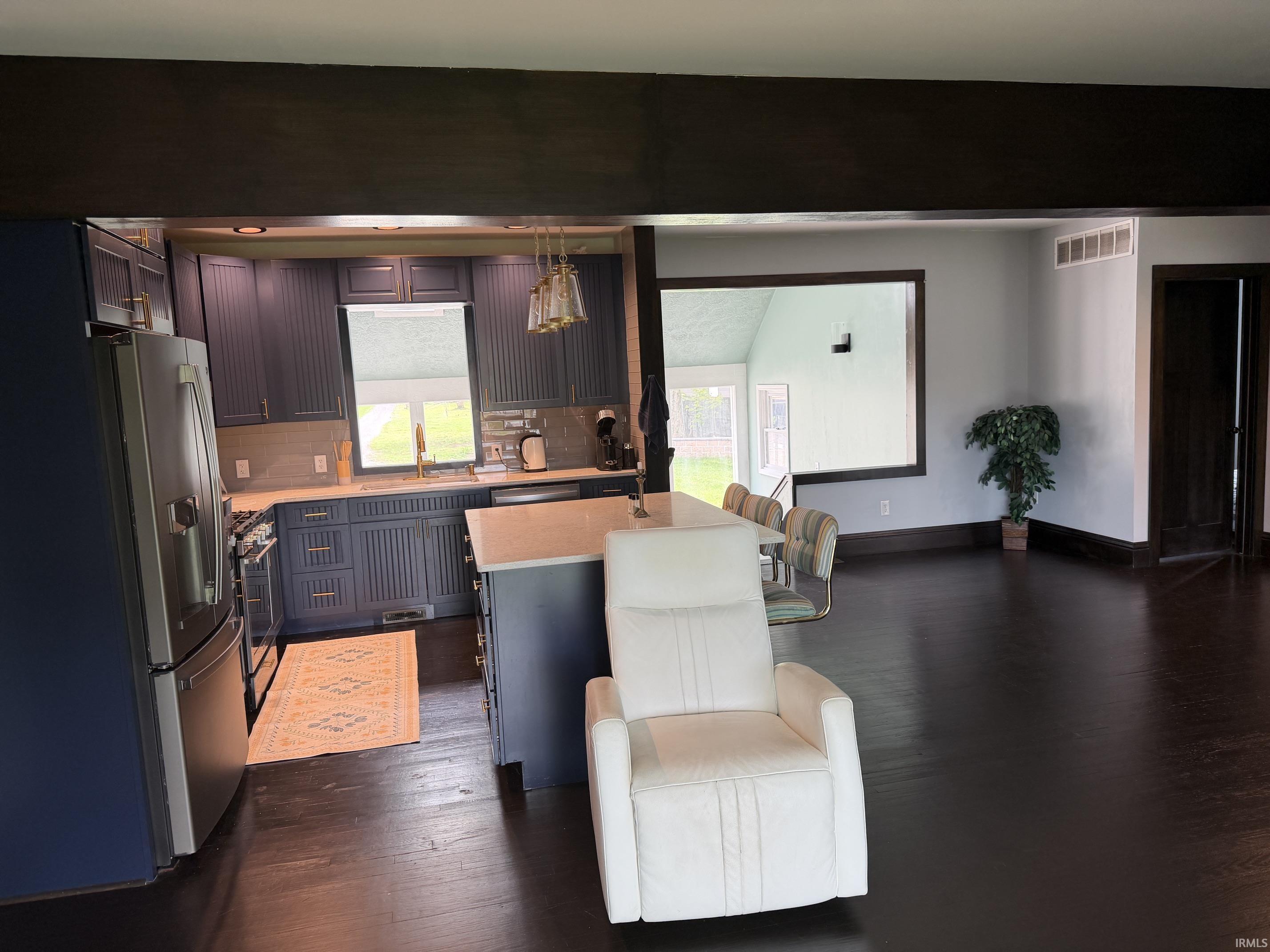 Open-concept living area featuring dark wood-finish flooring throughout