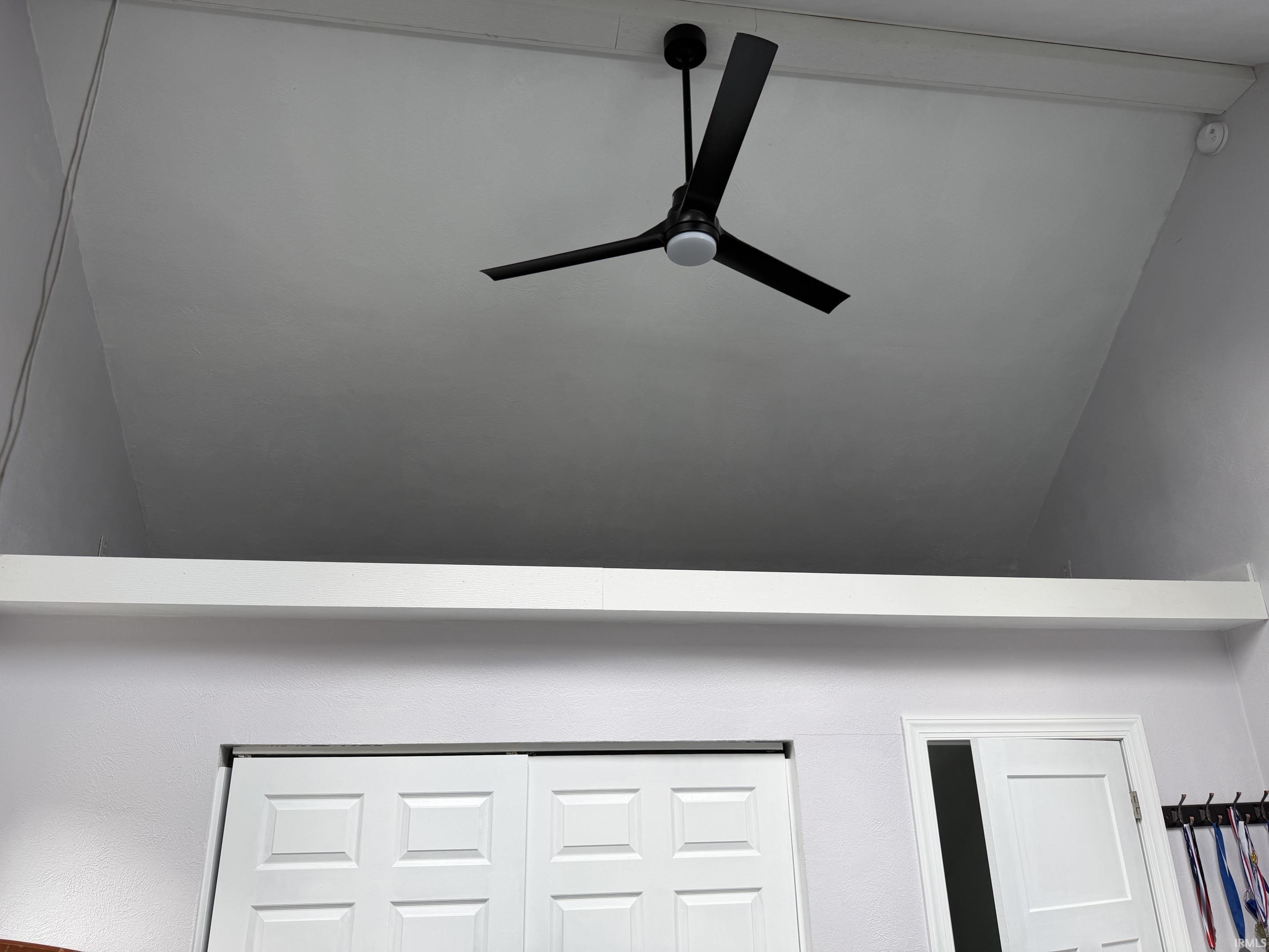 Vaulted ceiling with a contemporary black ceiling fan