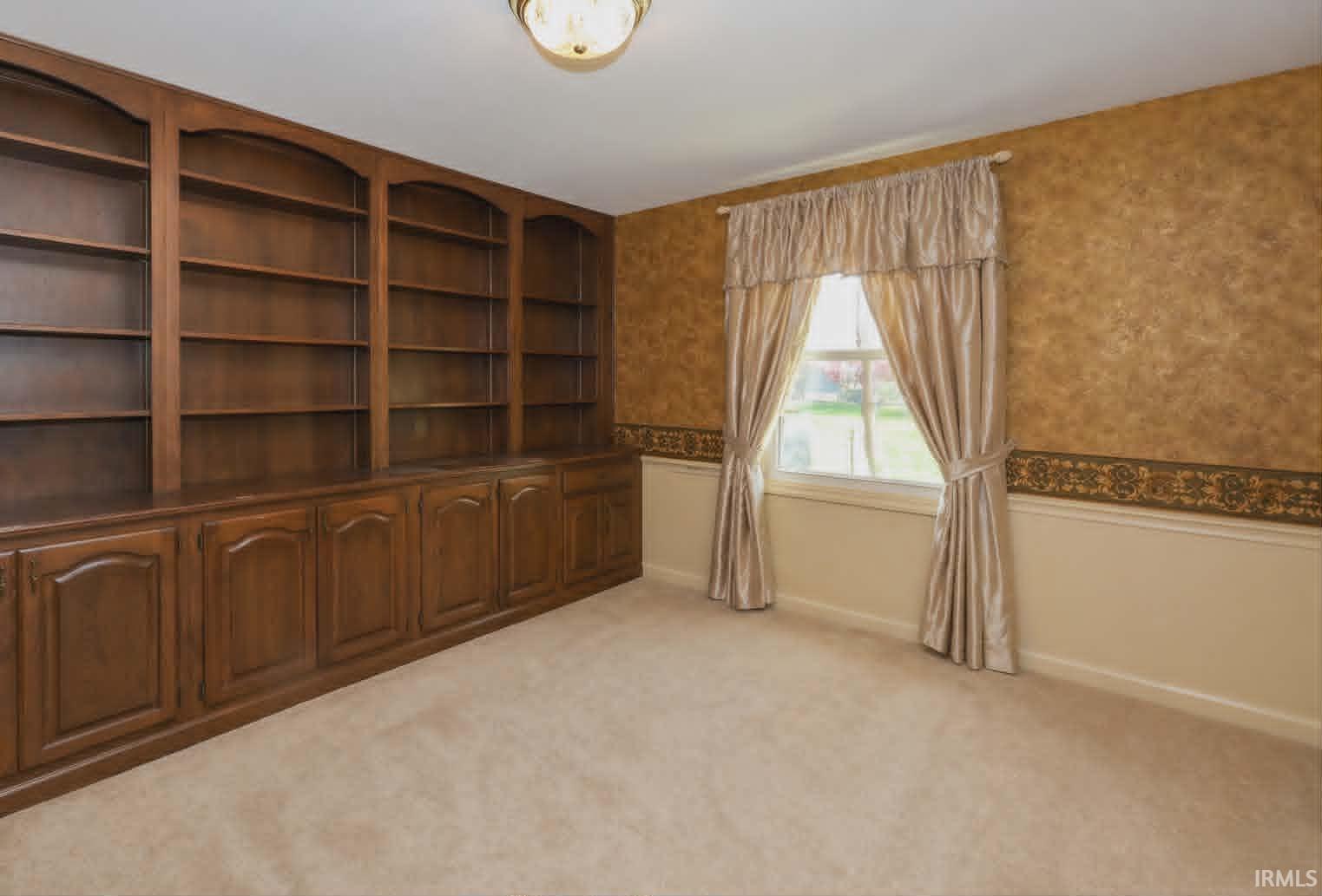 Built-in wood cabinetry and shelving along one wall