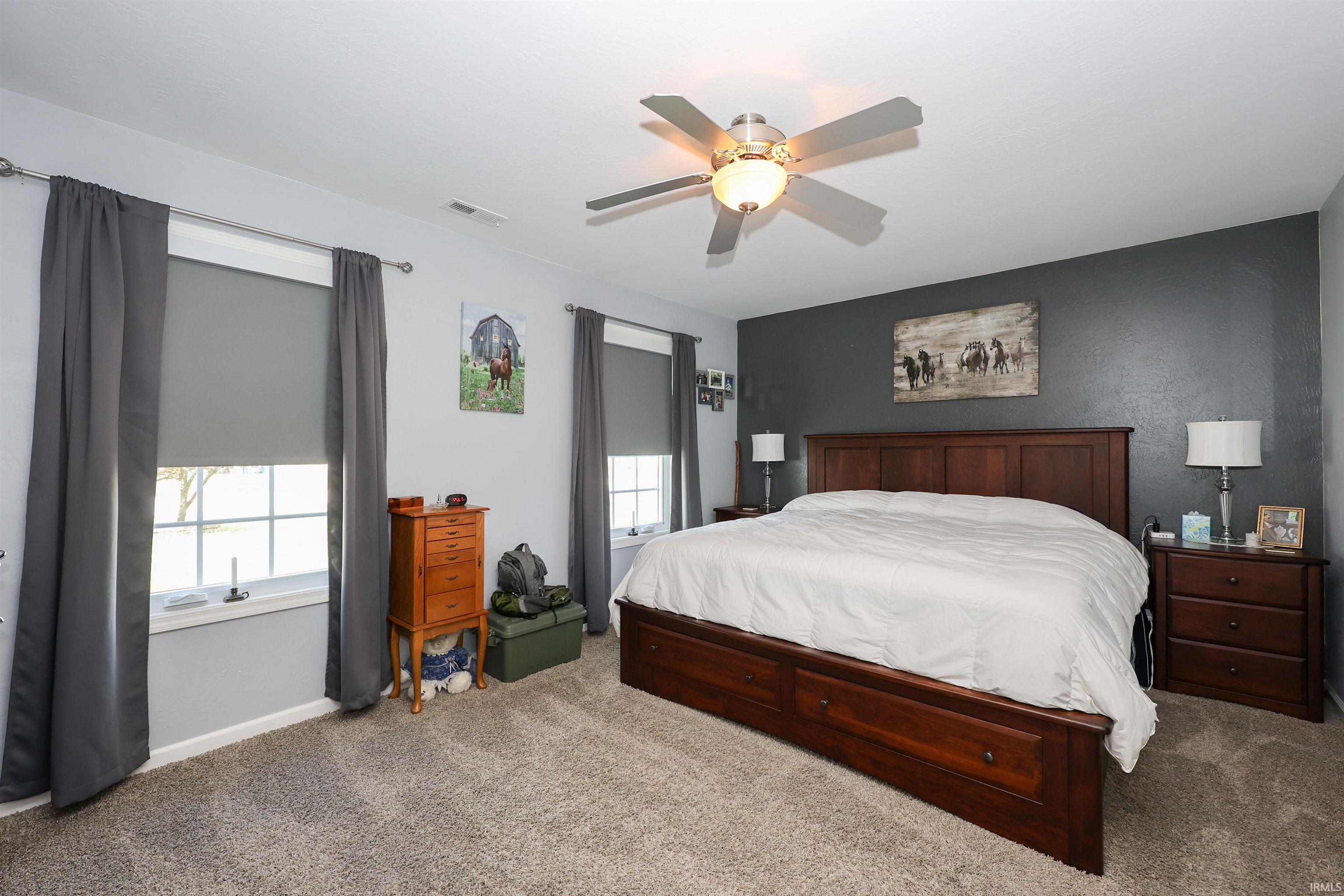 Spacious room featuring neutral carpeting and a contrasting accent wall