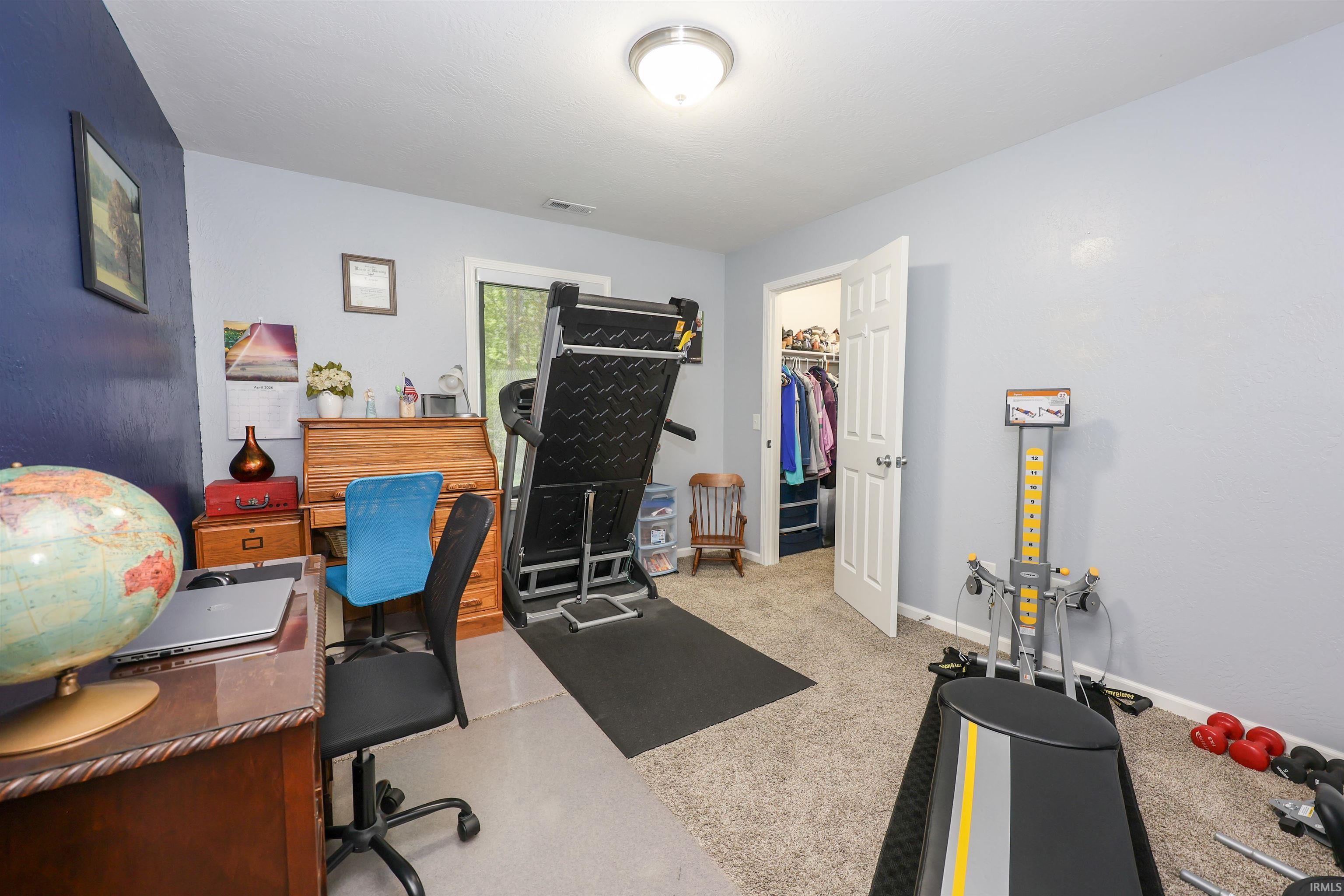 Carpeted room with light grey walls and a dark accent wall