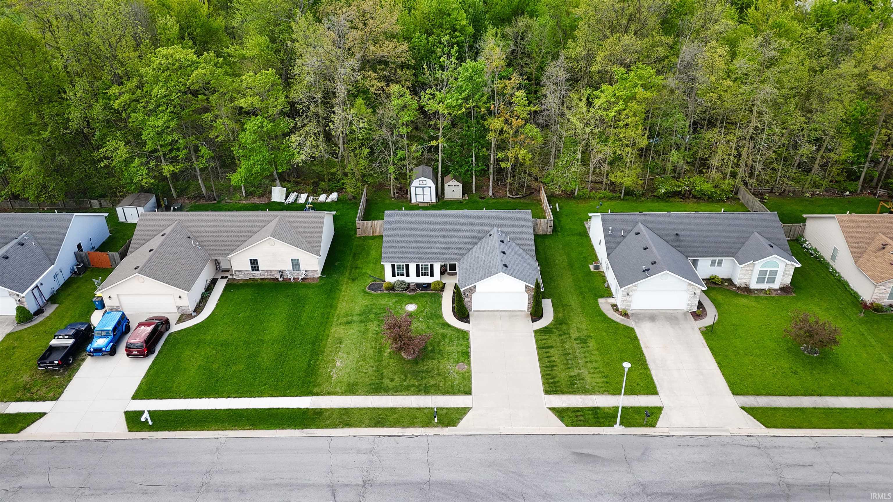 Single-story residence featuring a gray shingle roof, white exterior siding, and an attached two-car garage