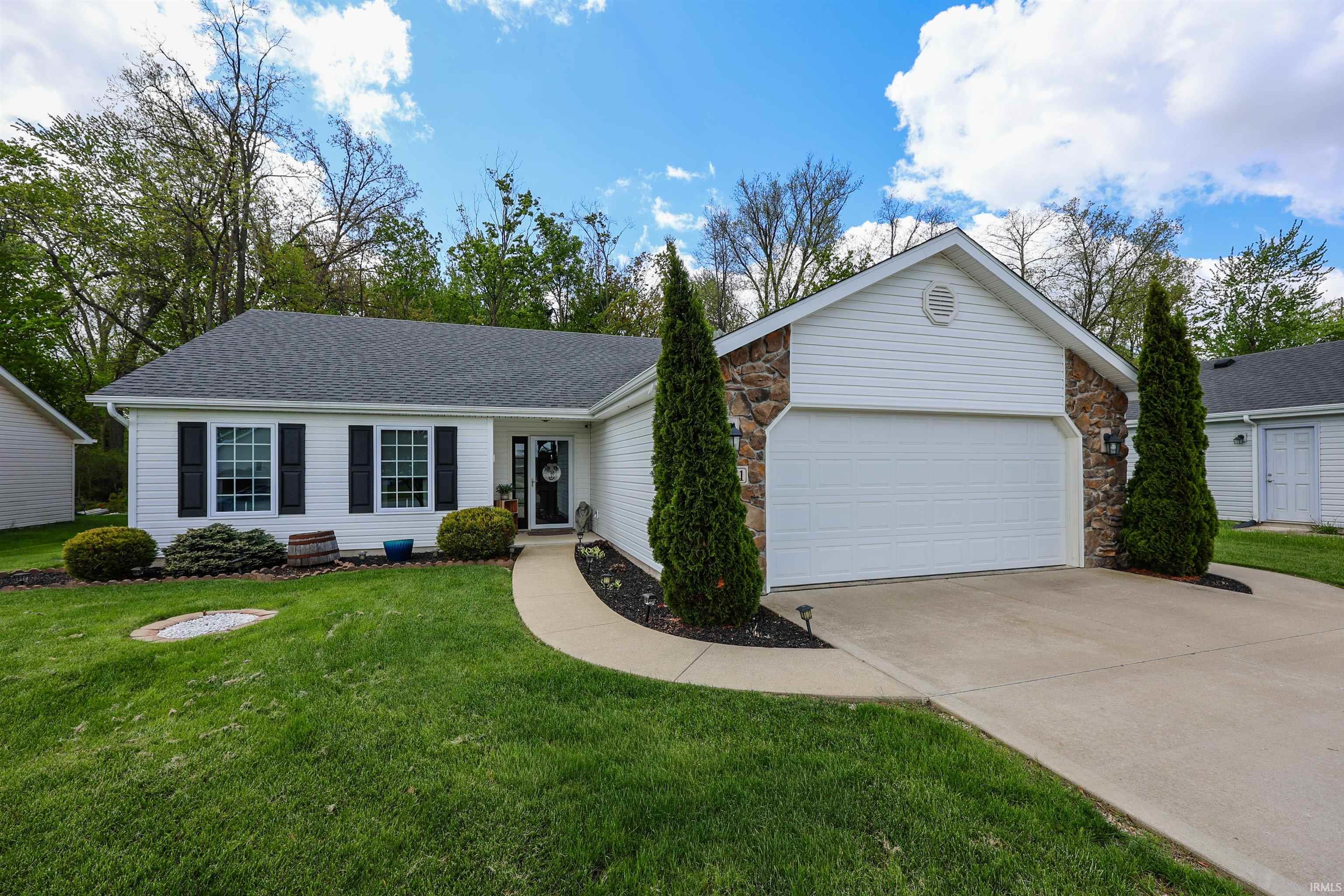 Ranch-style exterior featuring white siding and stone accents