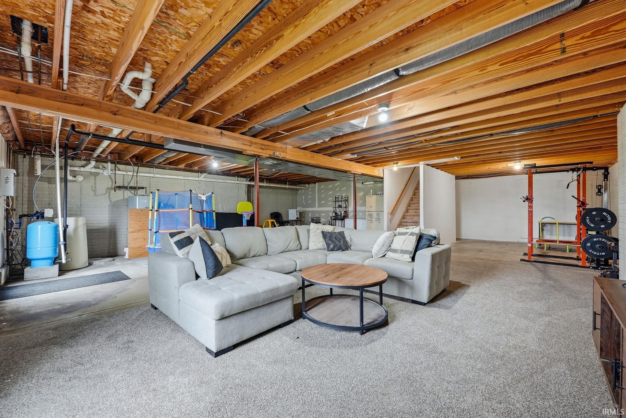 Spacious lower level featuring exposed wood joists and an open layout