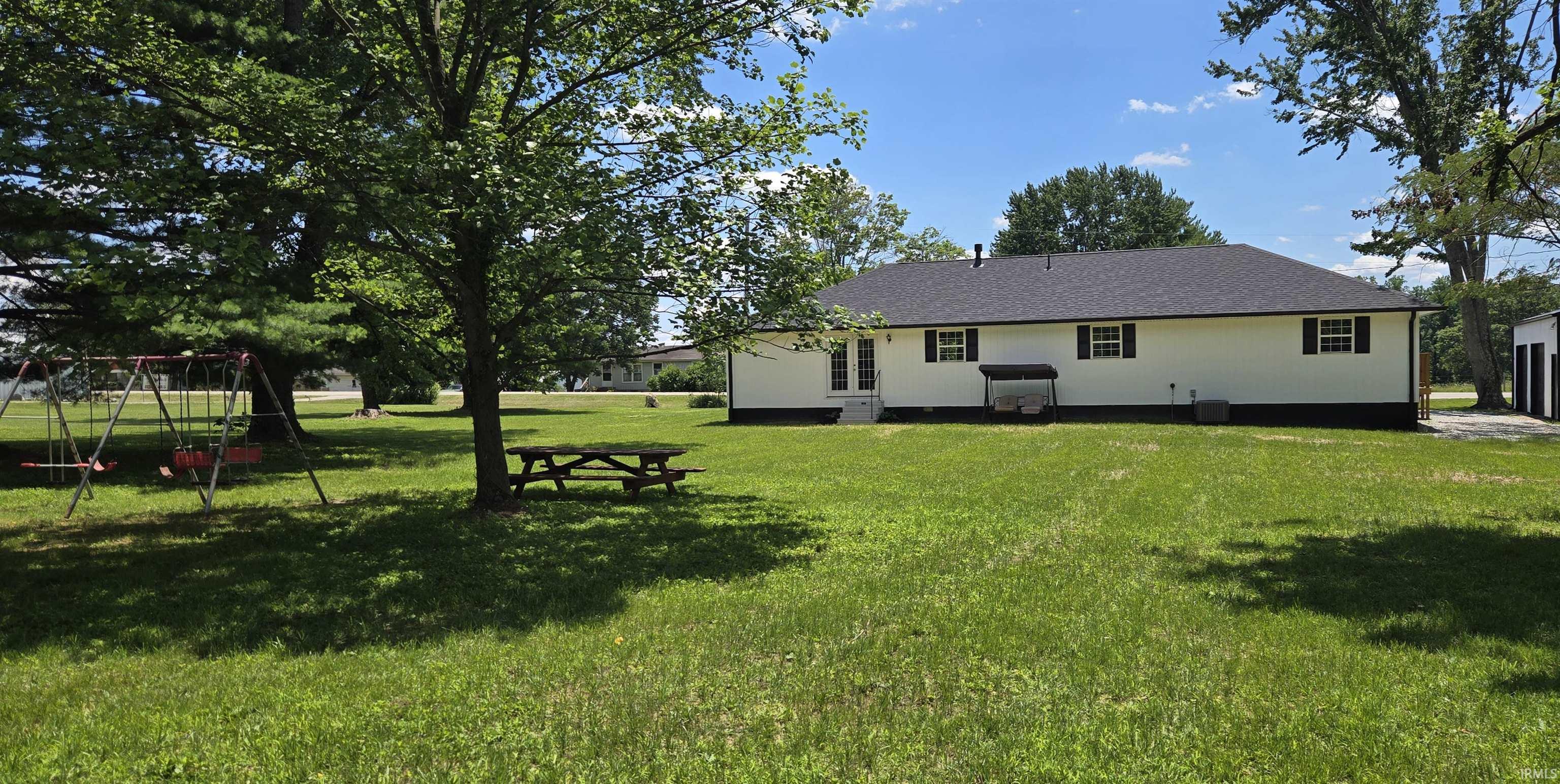 ranch style home with a 24x32 outdoor building.