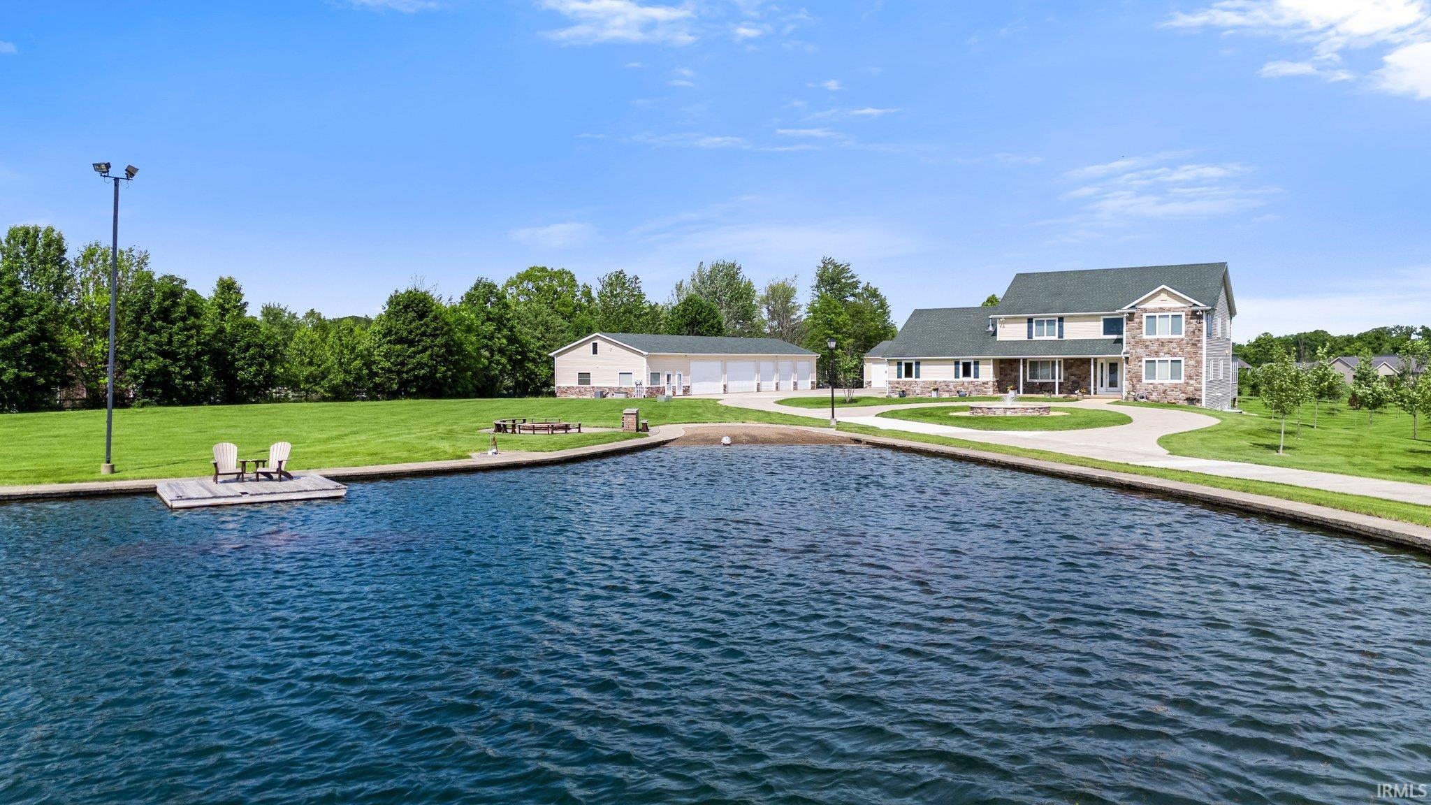 Expansive property featuring a large body of water with a floating dock