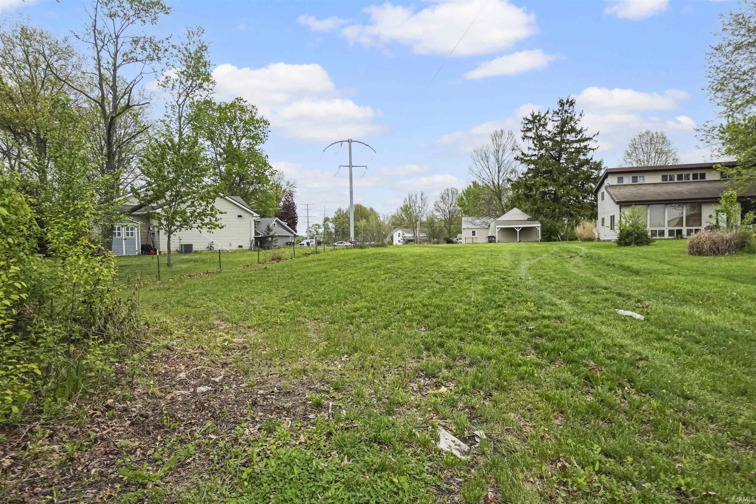 Expansive green space with an open, rolling lawn